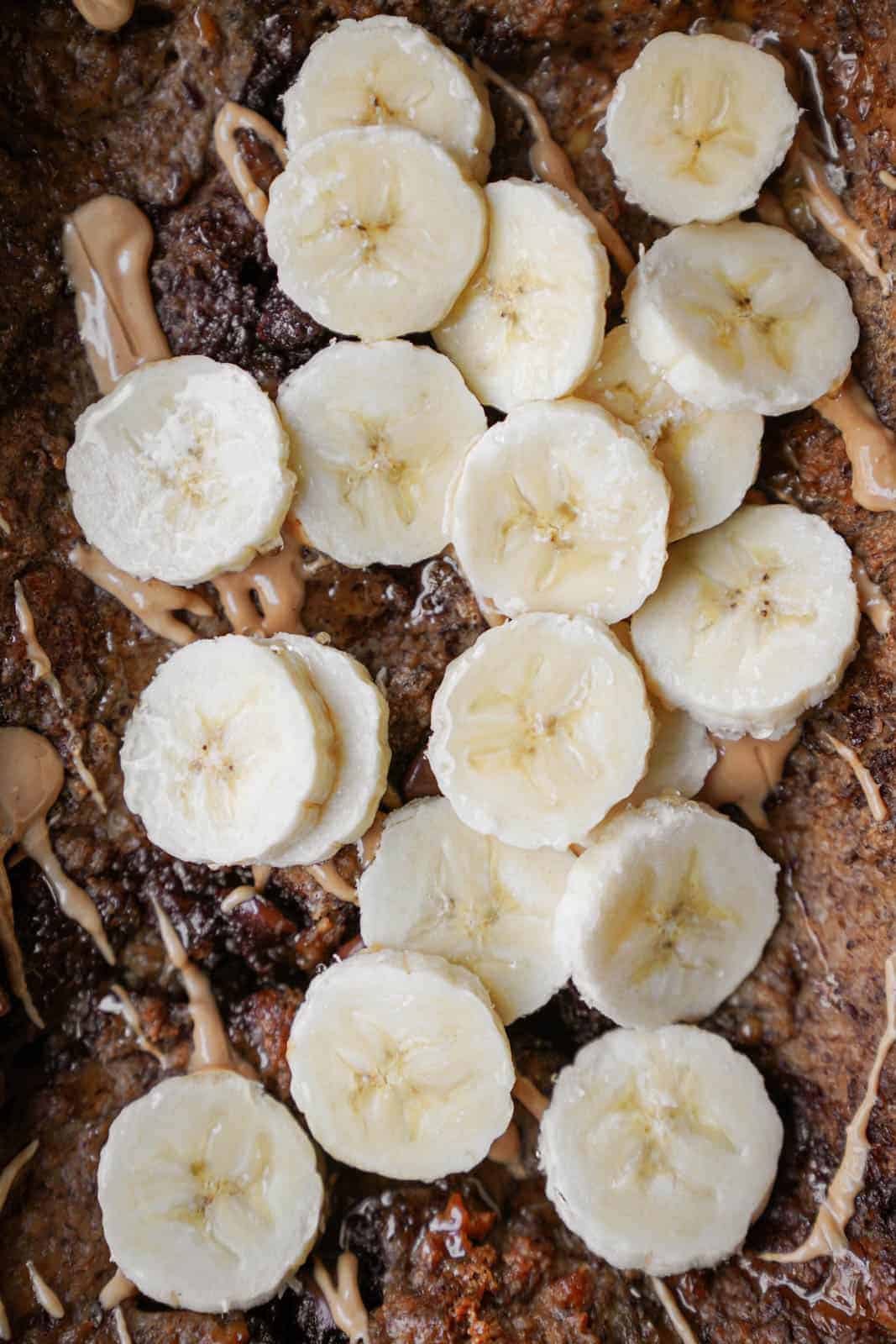 Vegan baked oatmeal with bananas cut on top.