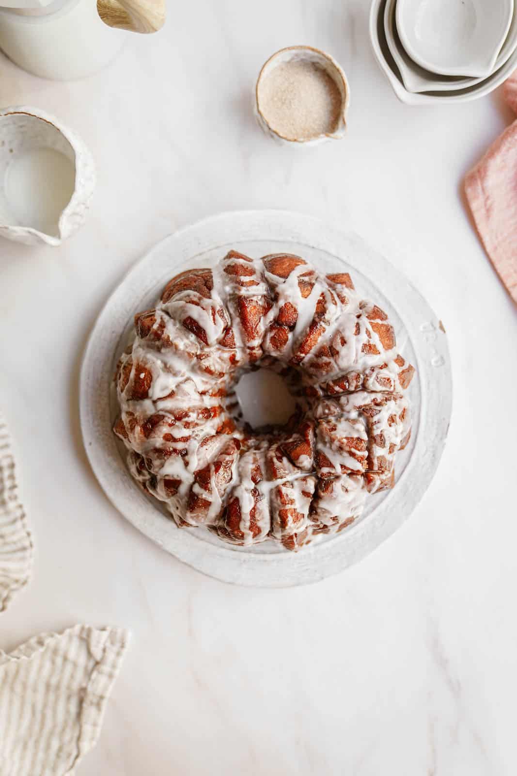 Vegan monkey bread on plate drizzled with icing