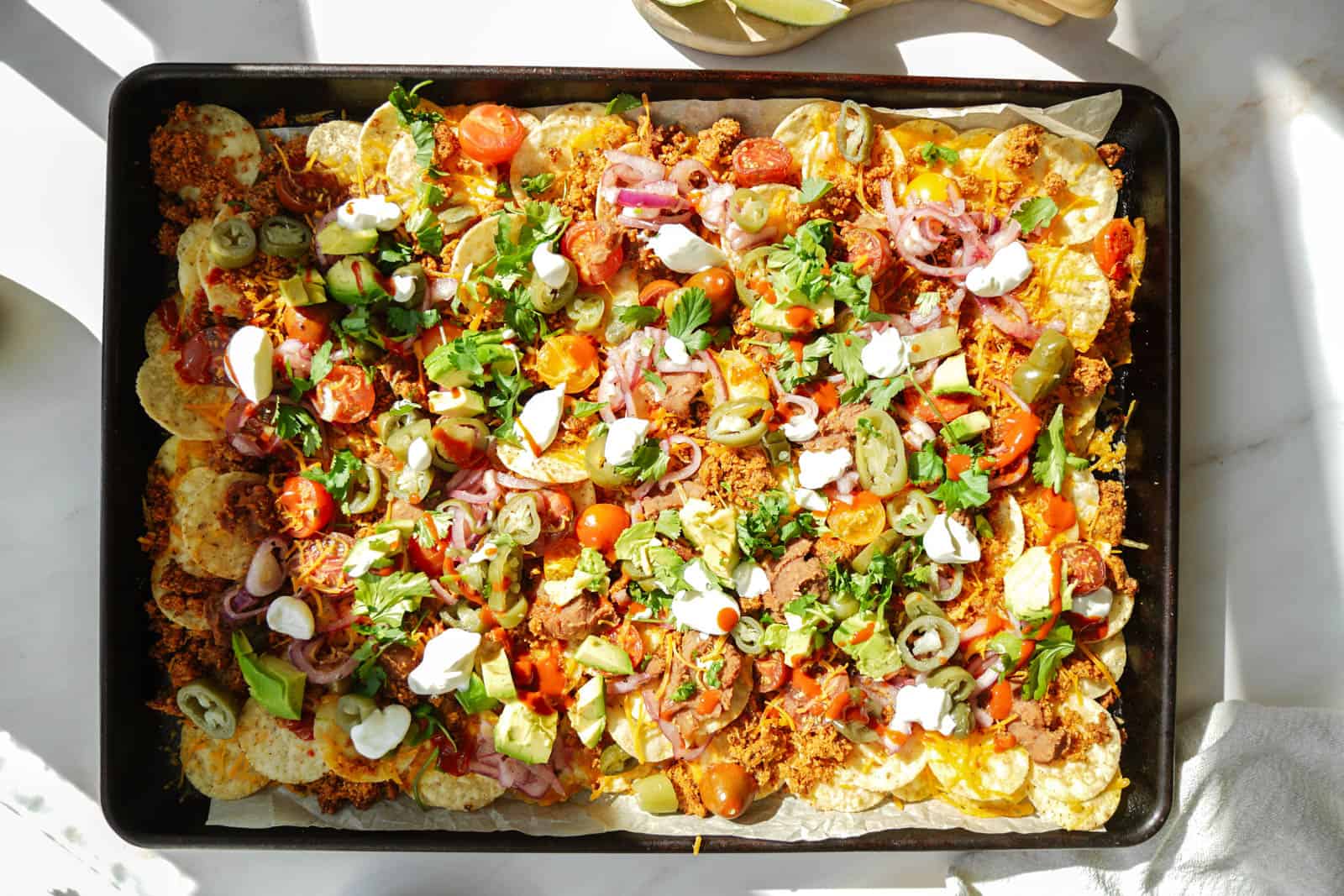 Vegan Taco Meat Nachos on a big baking sheet