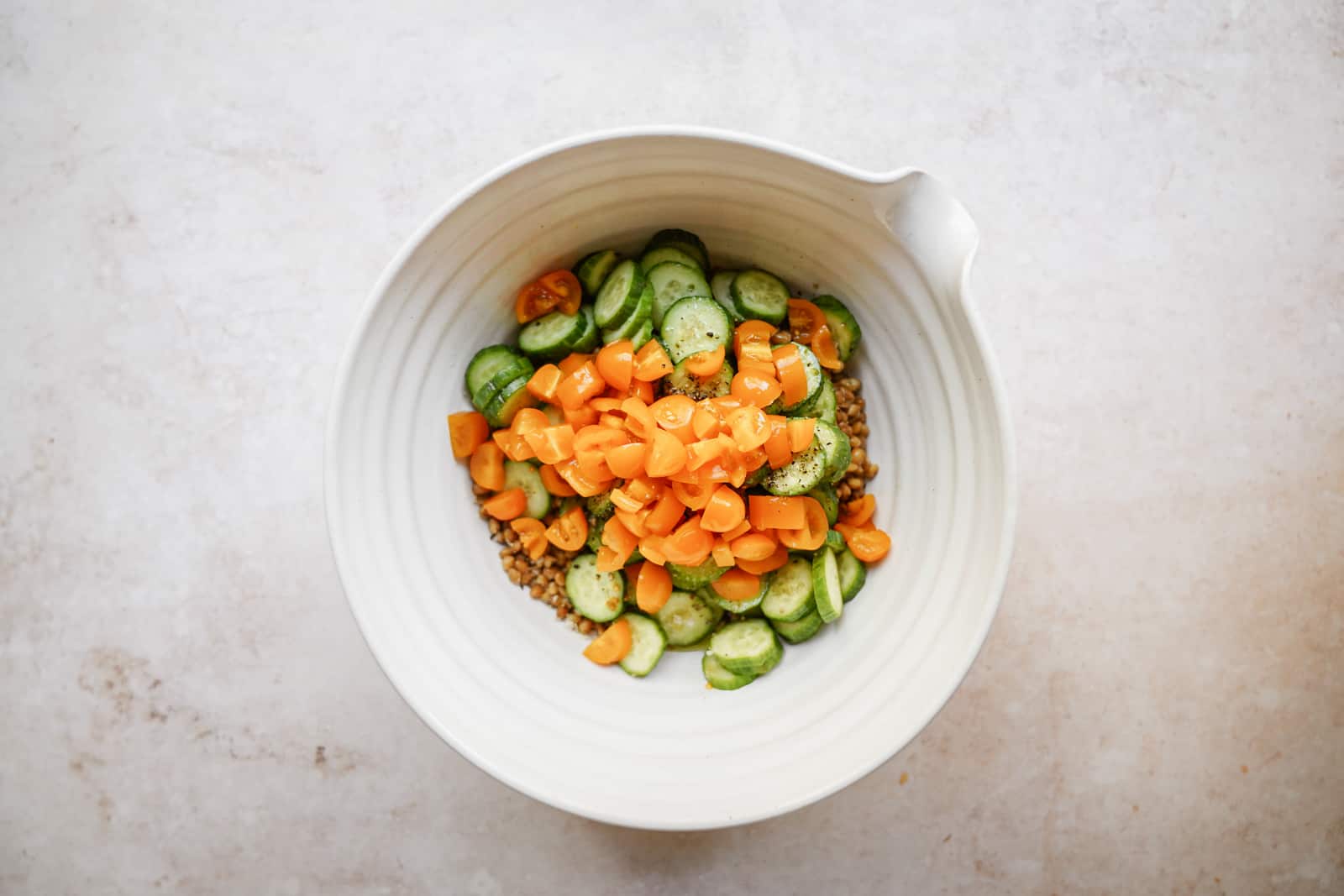 Step-by-step ingredients being added to a bowl for grilled romaine salad