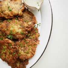 Zucchini Potato Pancakes on serving plate with dipping sauce