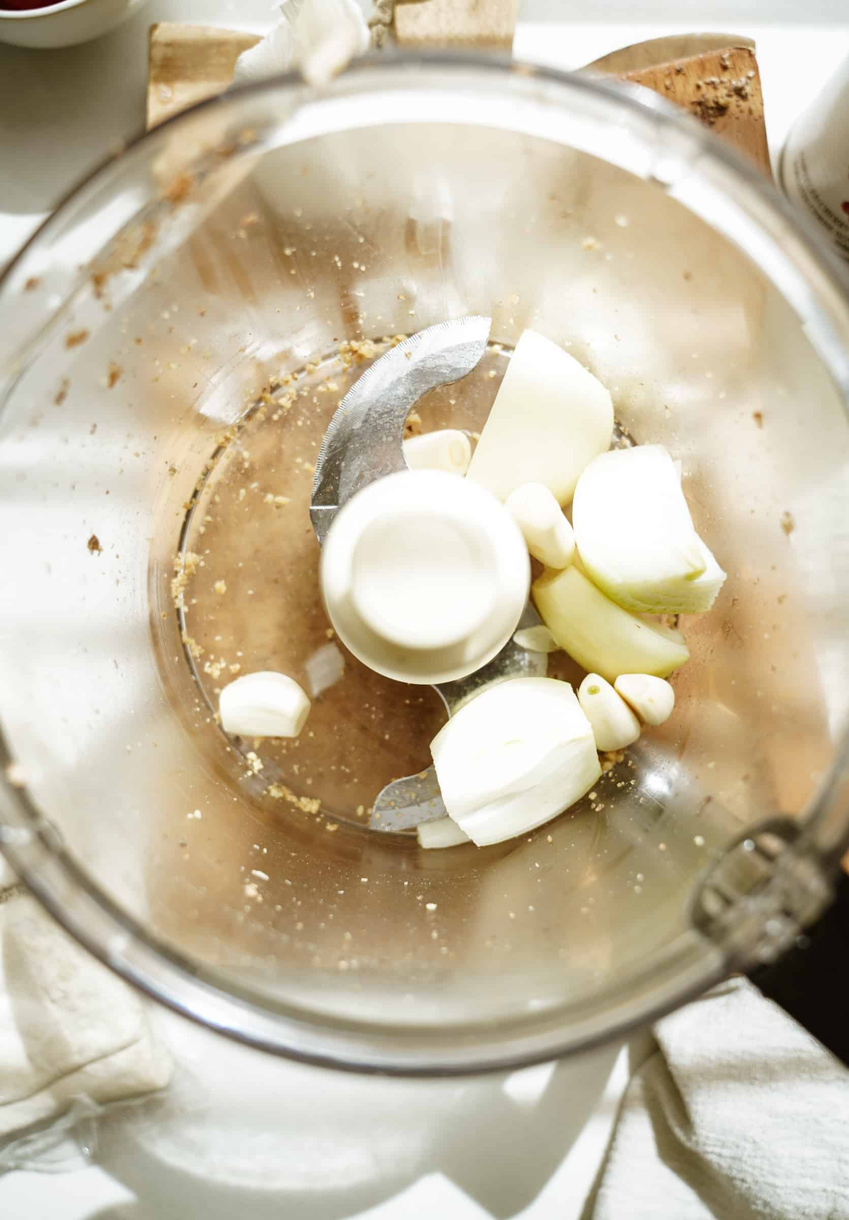 Garlic and onion in a food processor for walnut meat hot pockets