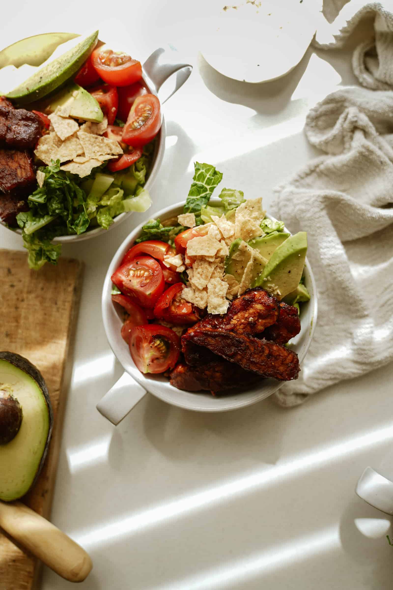 BBQ tempeh bowls on counter with fresh veggies