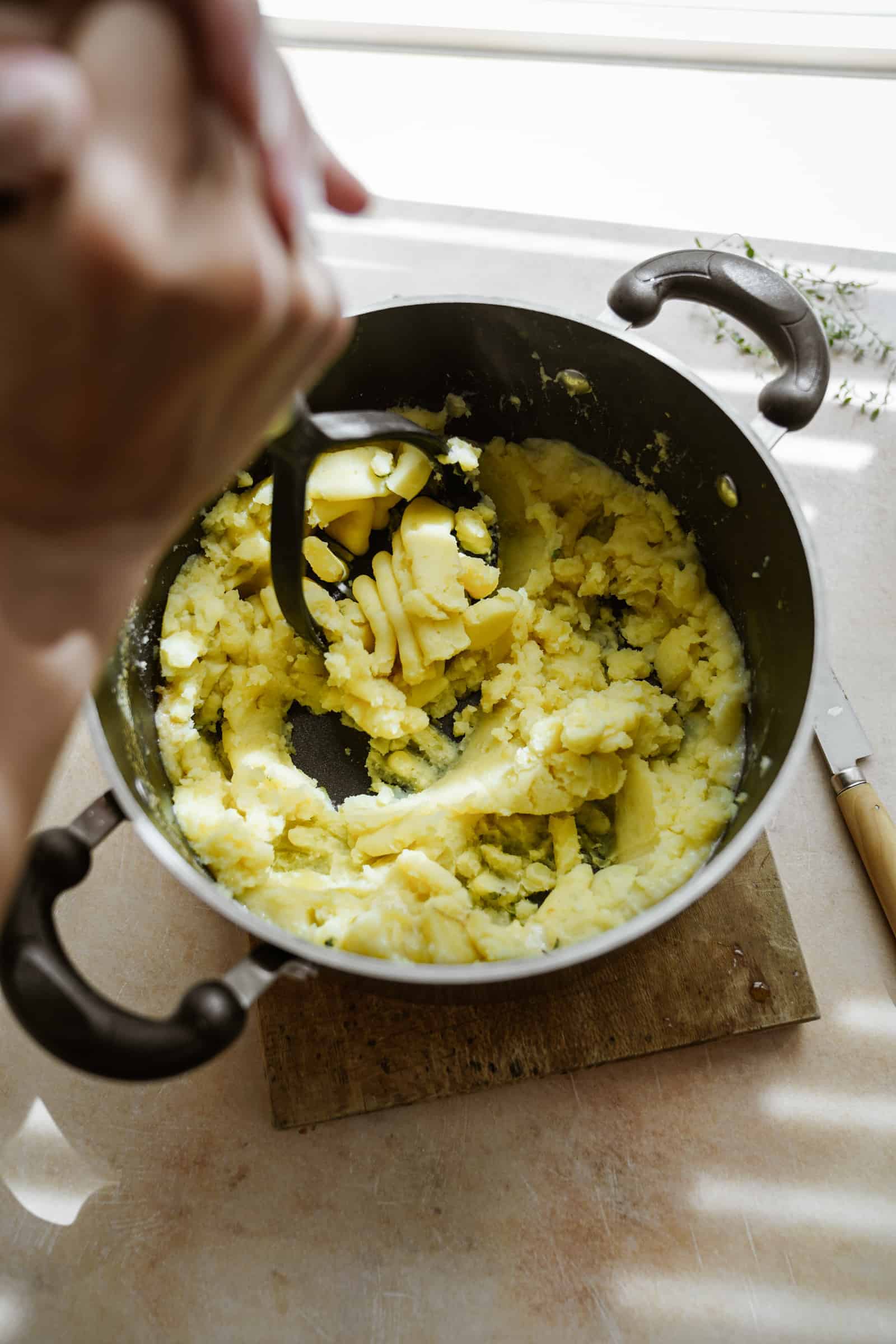 Mashing potatoes in pot