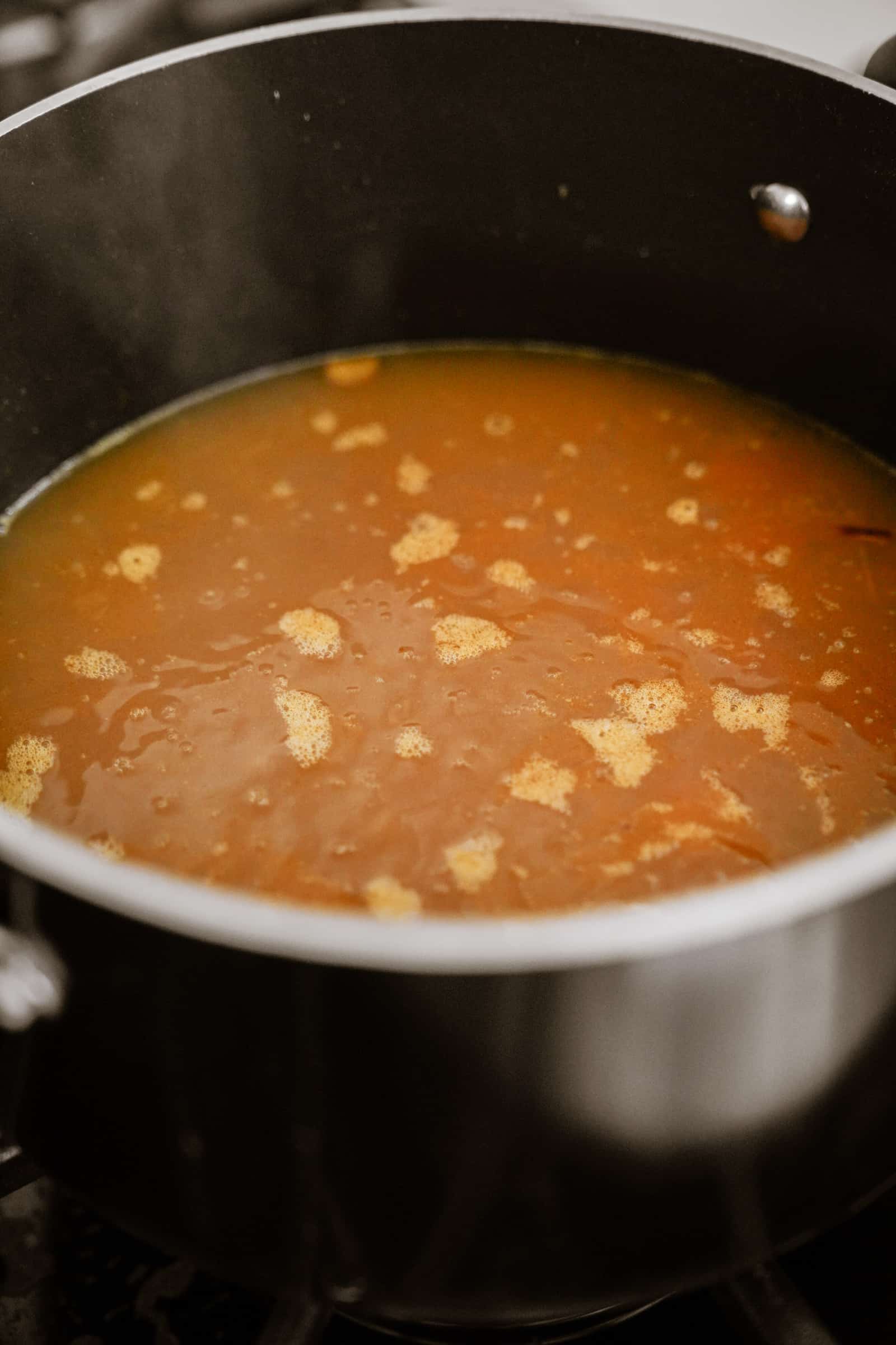 Lemon rice soup cooking in a pot