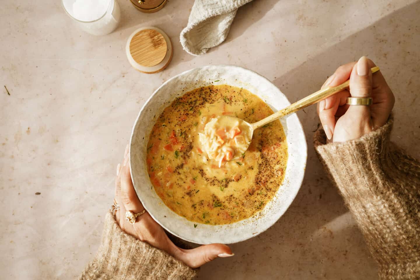 Bowl of lemon rice soup with a spoon it in