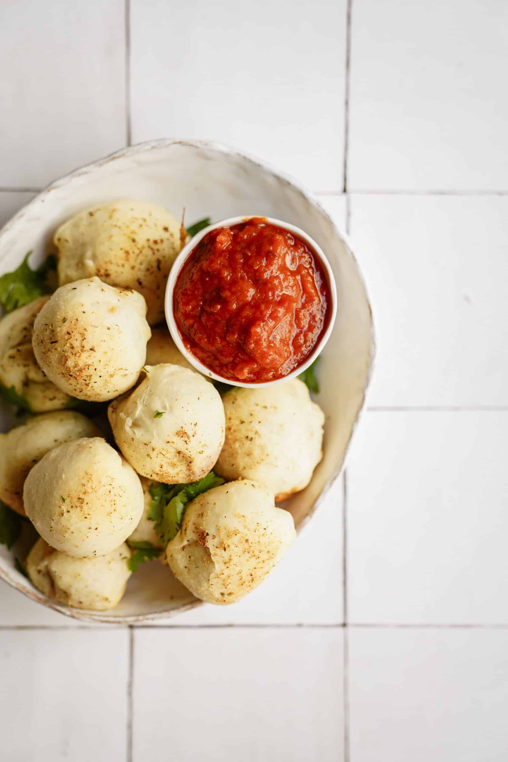 homemade pizza pockets in bowl with dip