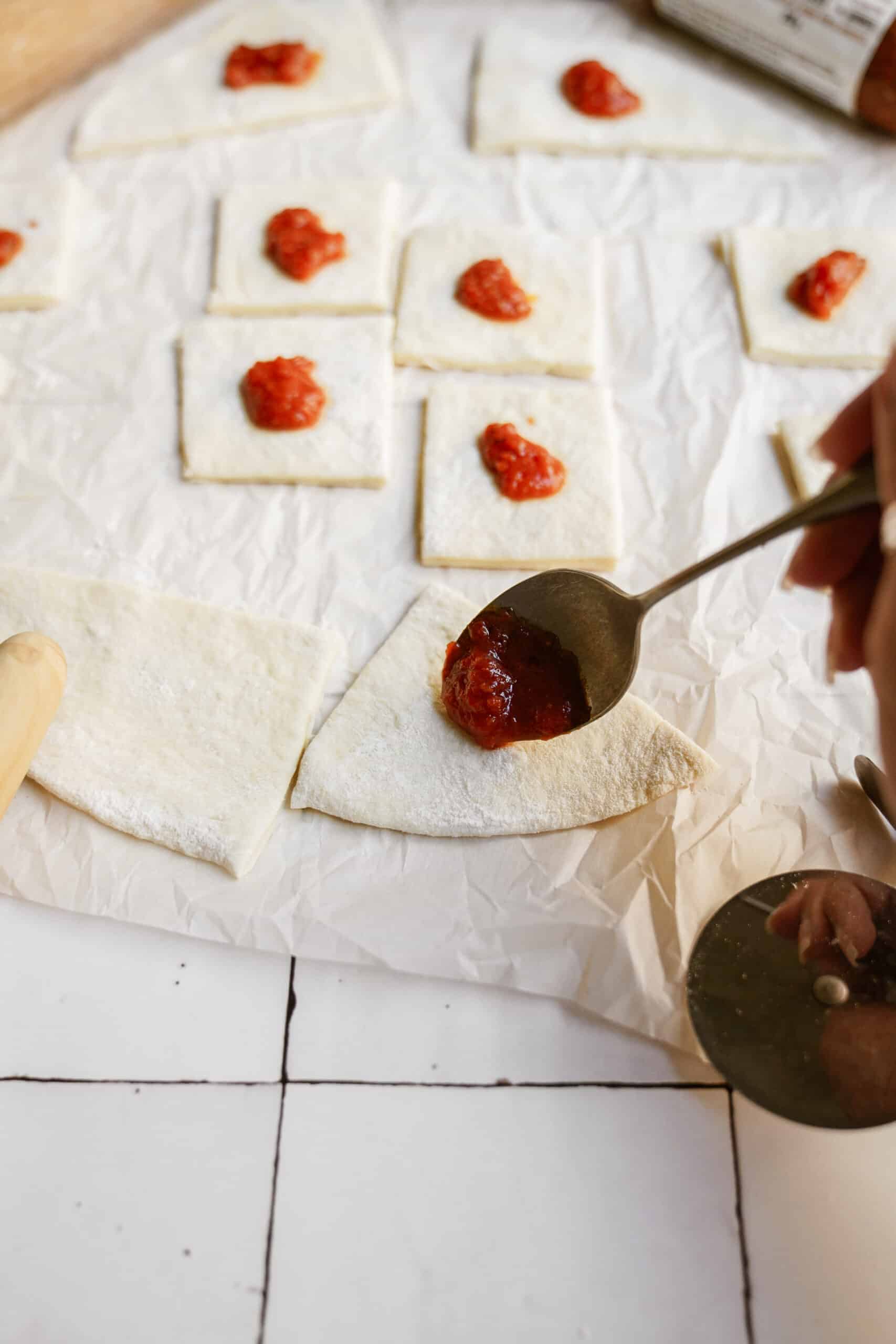 Dollop of sauce on pizza dough