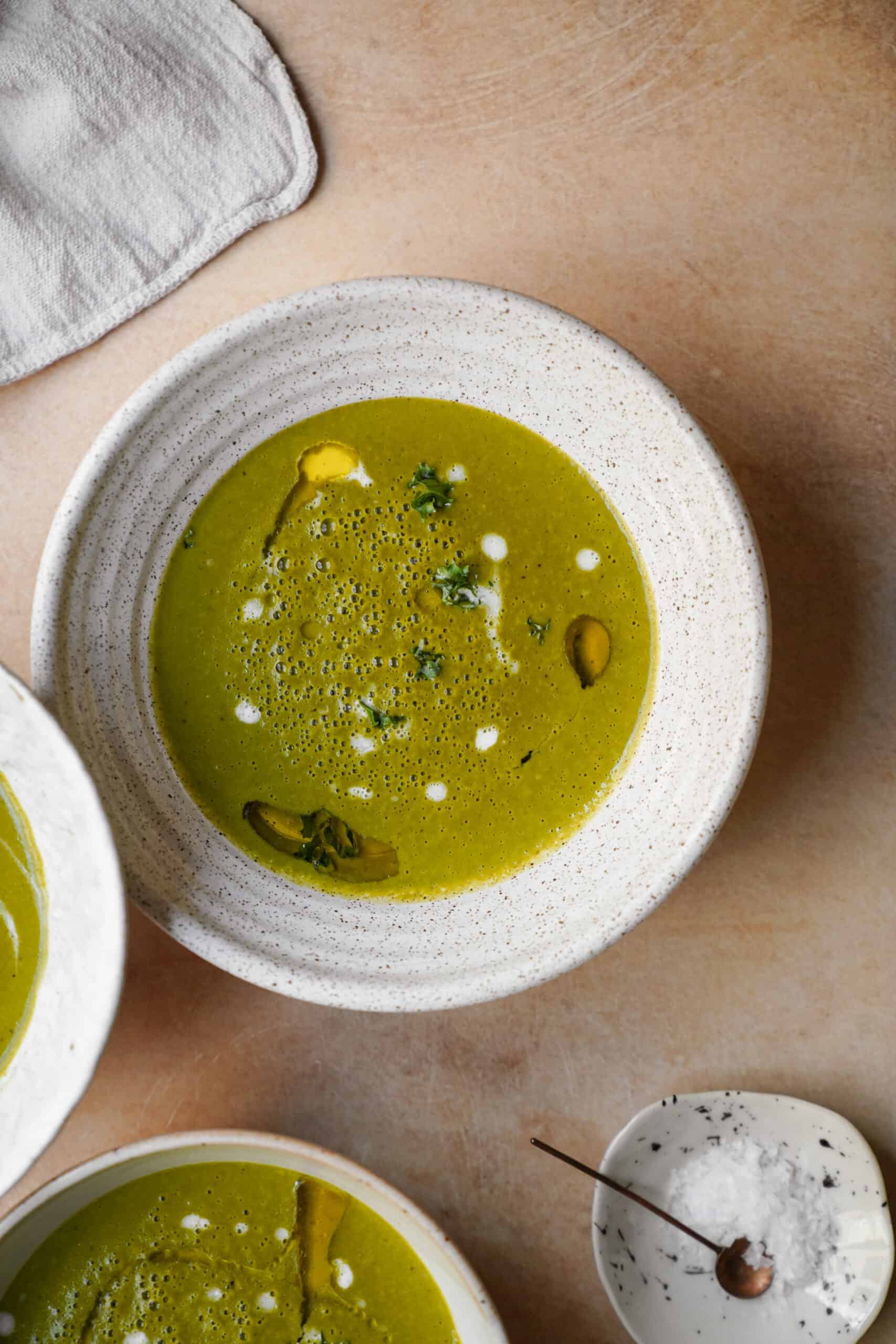 potato kale Soup in white bowl on countertop