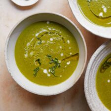 potato kale Soup in white bowl on countertop