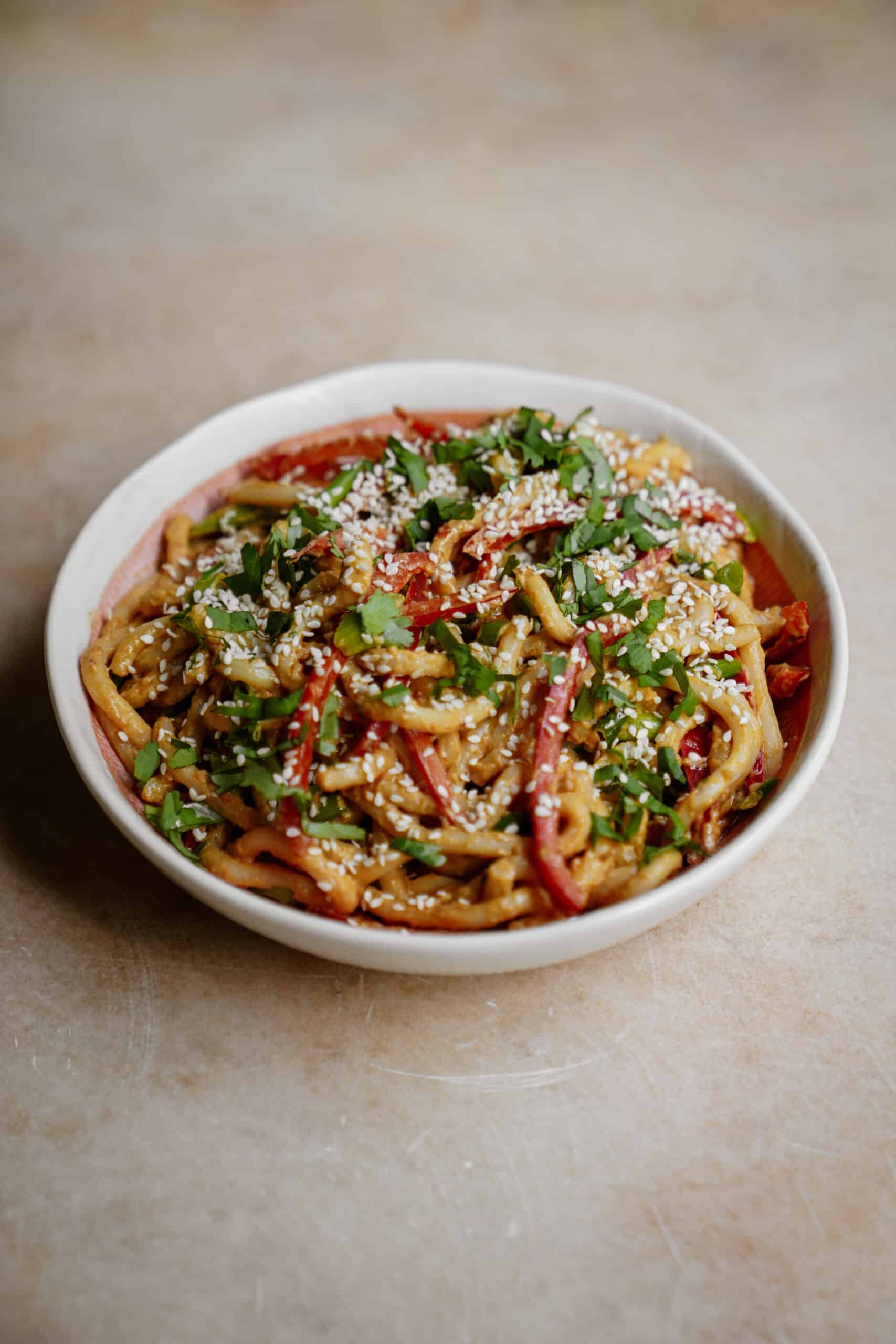 Spicy udon noodles in a white bowl