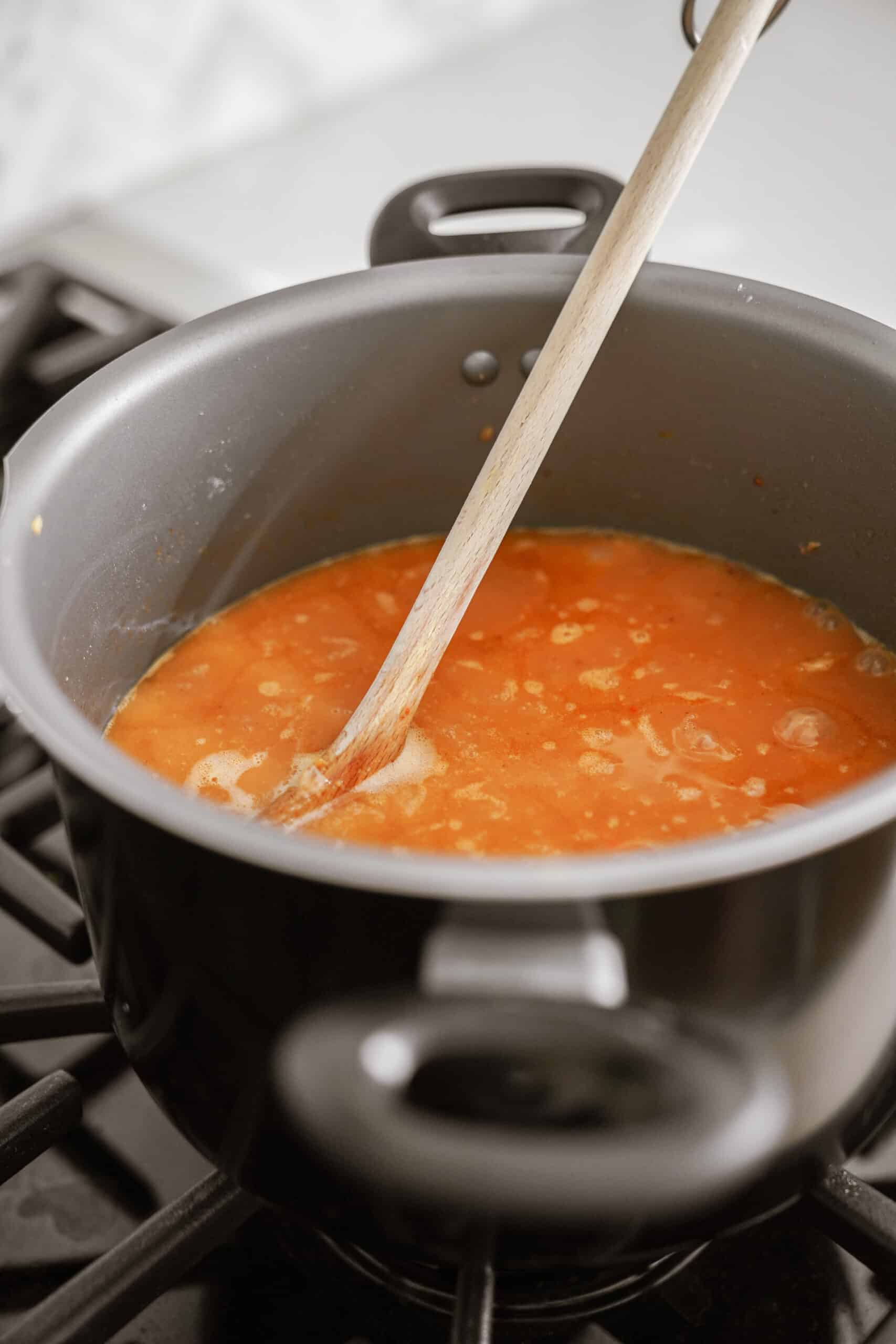 Pot of soup cooking on a stove