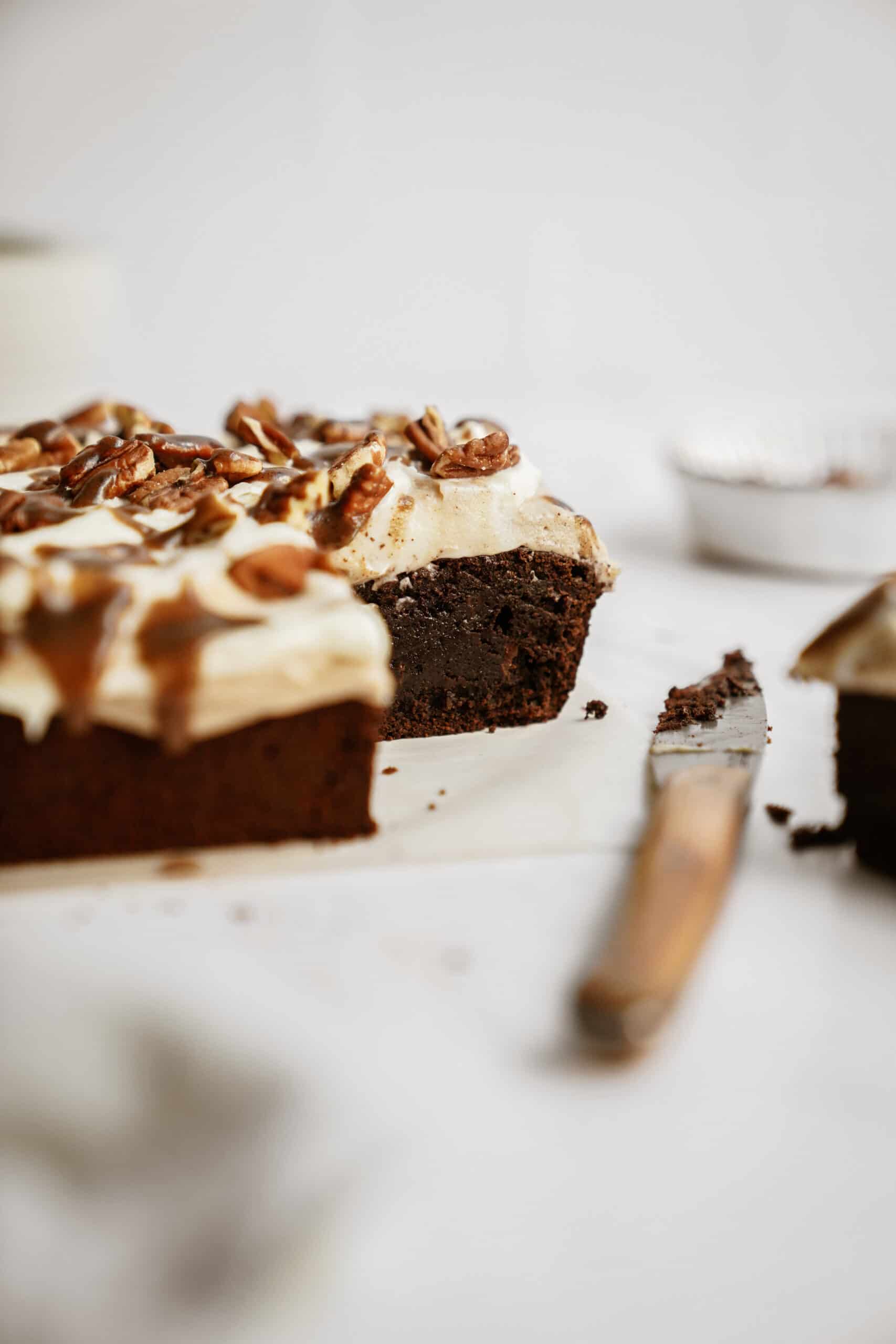 Fudge brownies on a counter with a slice out of it