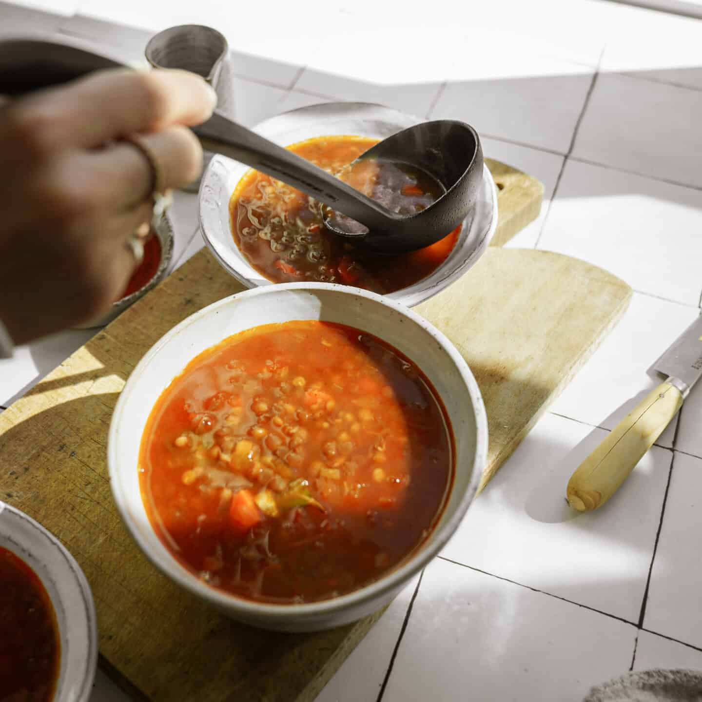 Lentil Soup being scooped into bowls