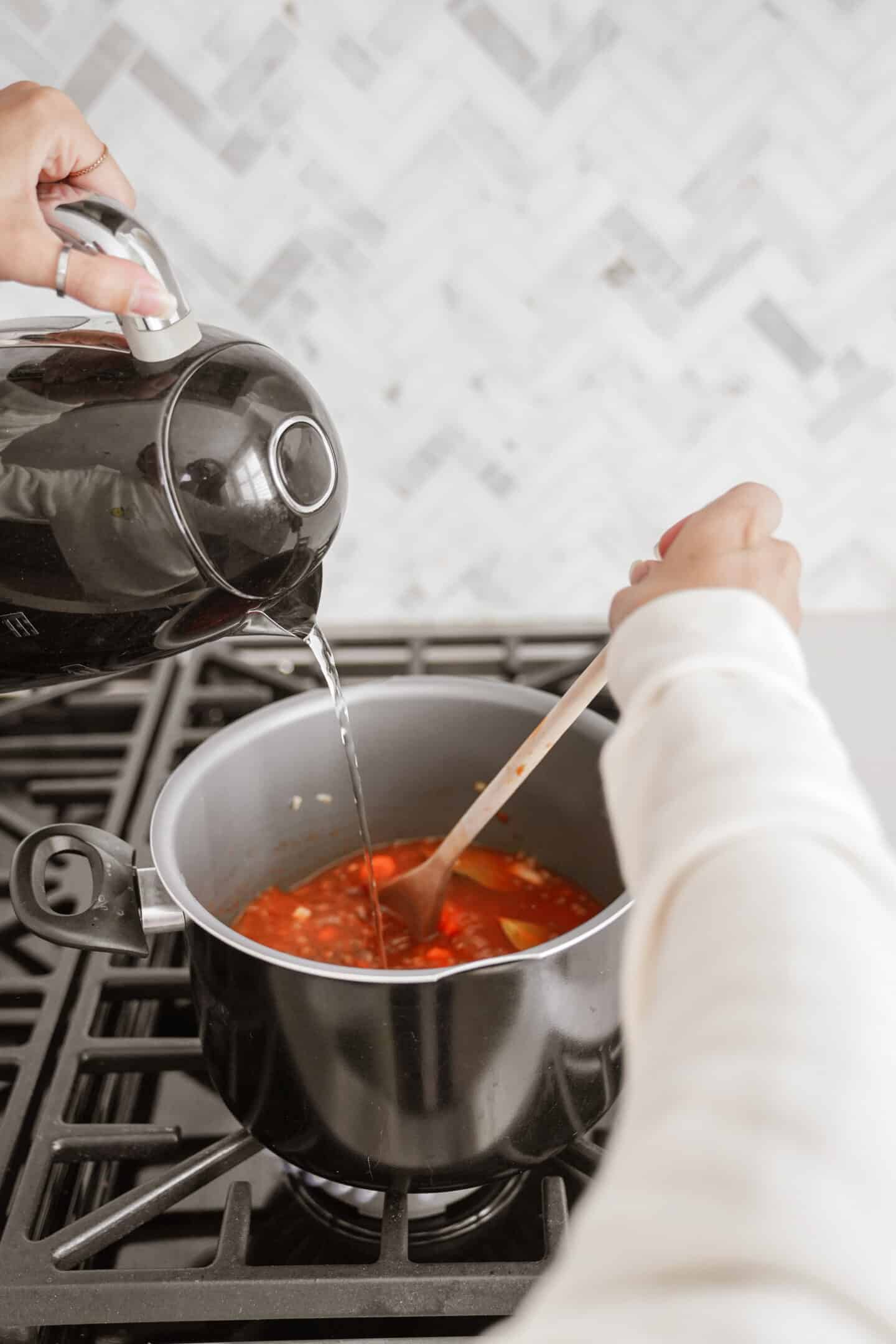 Water being added to Greek Lentil Soup