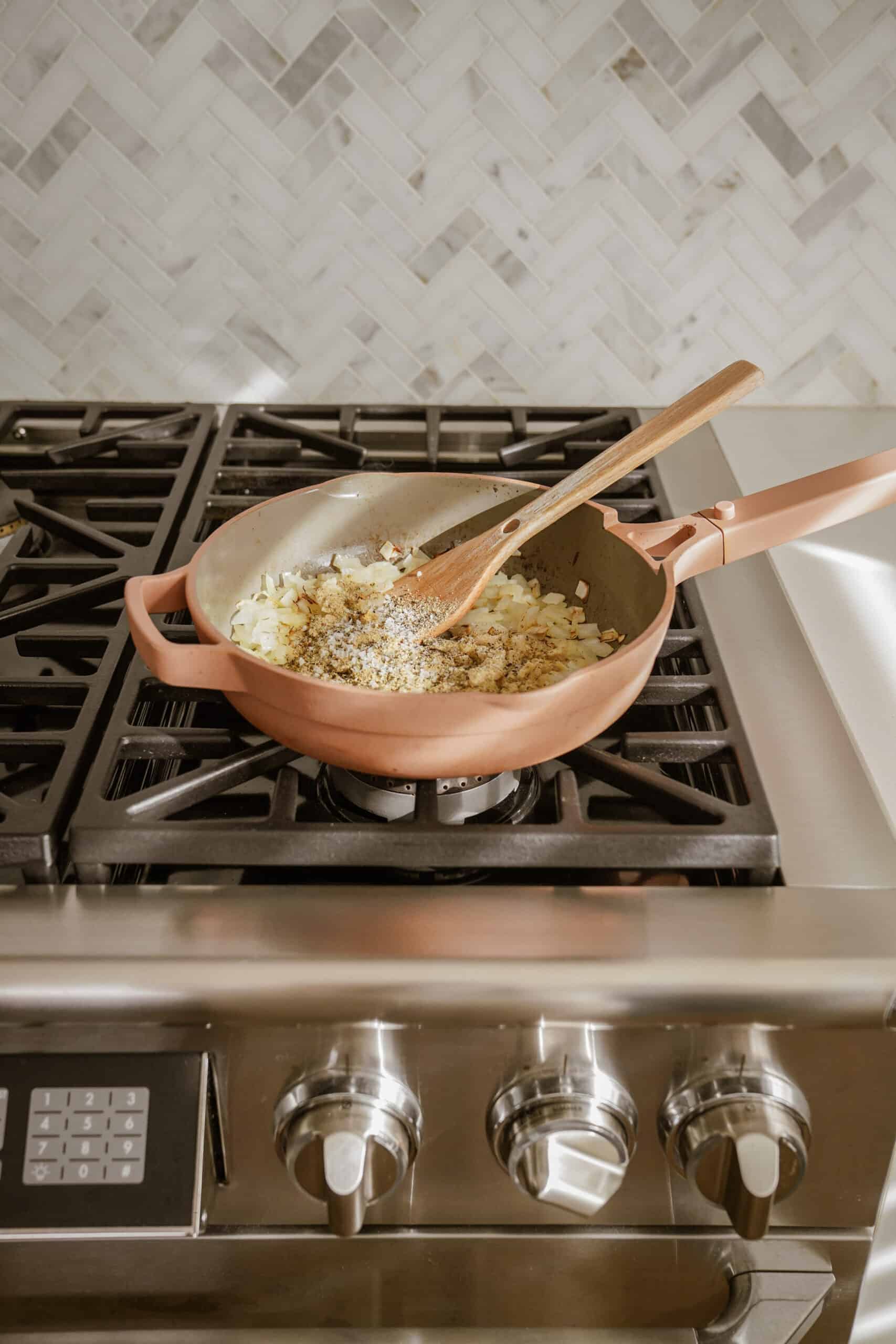 Onions in a pan for pesto pasta bake