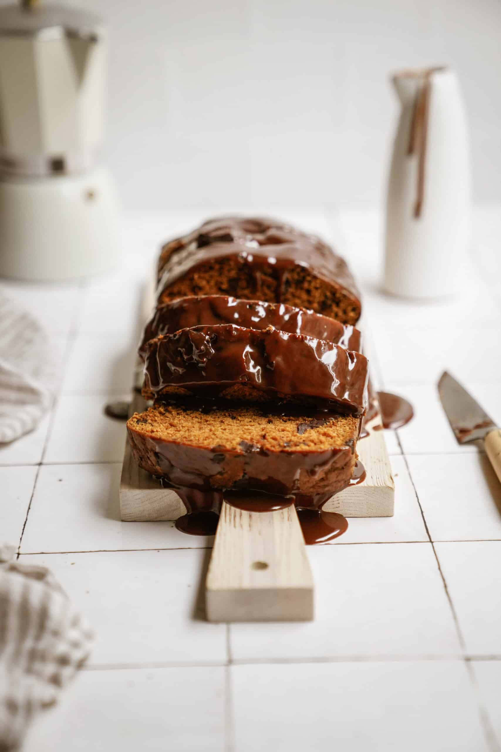 pumpkin chocolate chip bread sliced on a cutting board