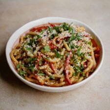 Creamy udon noodles with peanut sauce in a bowl