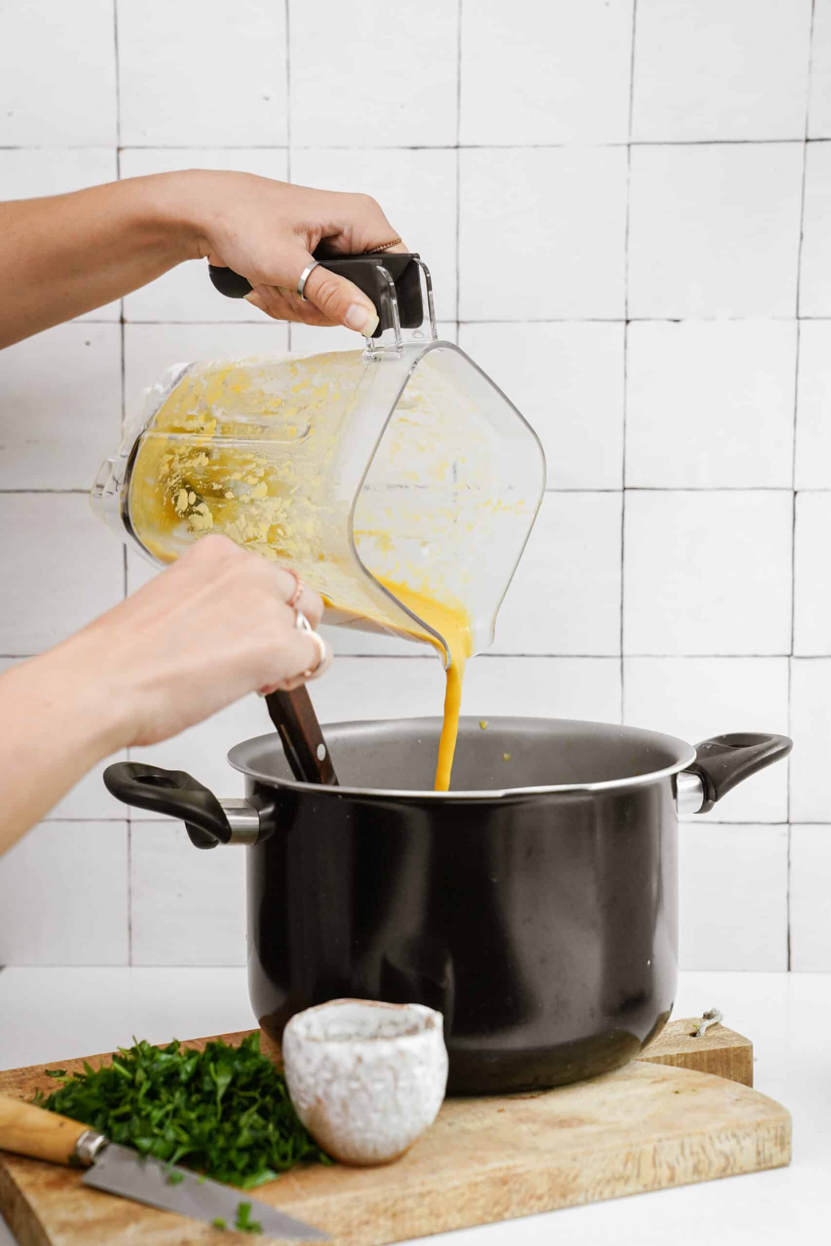 Blended soup being poured into a pot