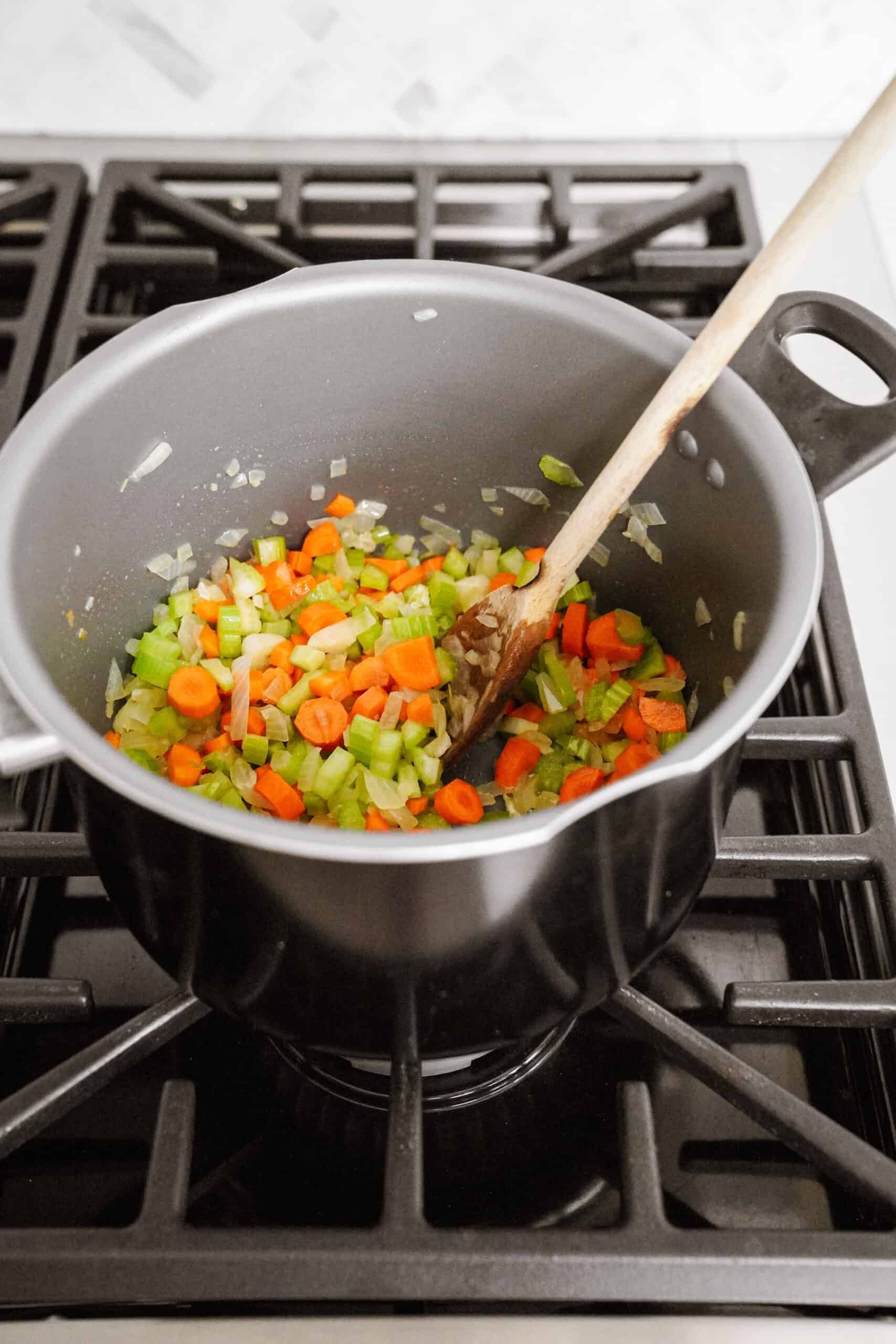 Veggies in a soup pot for creamy bean soup