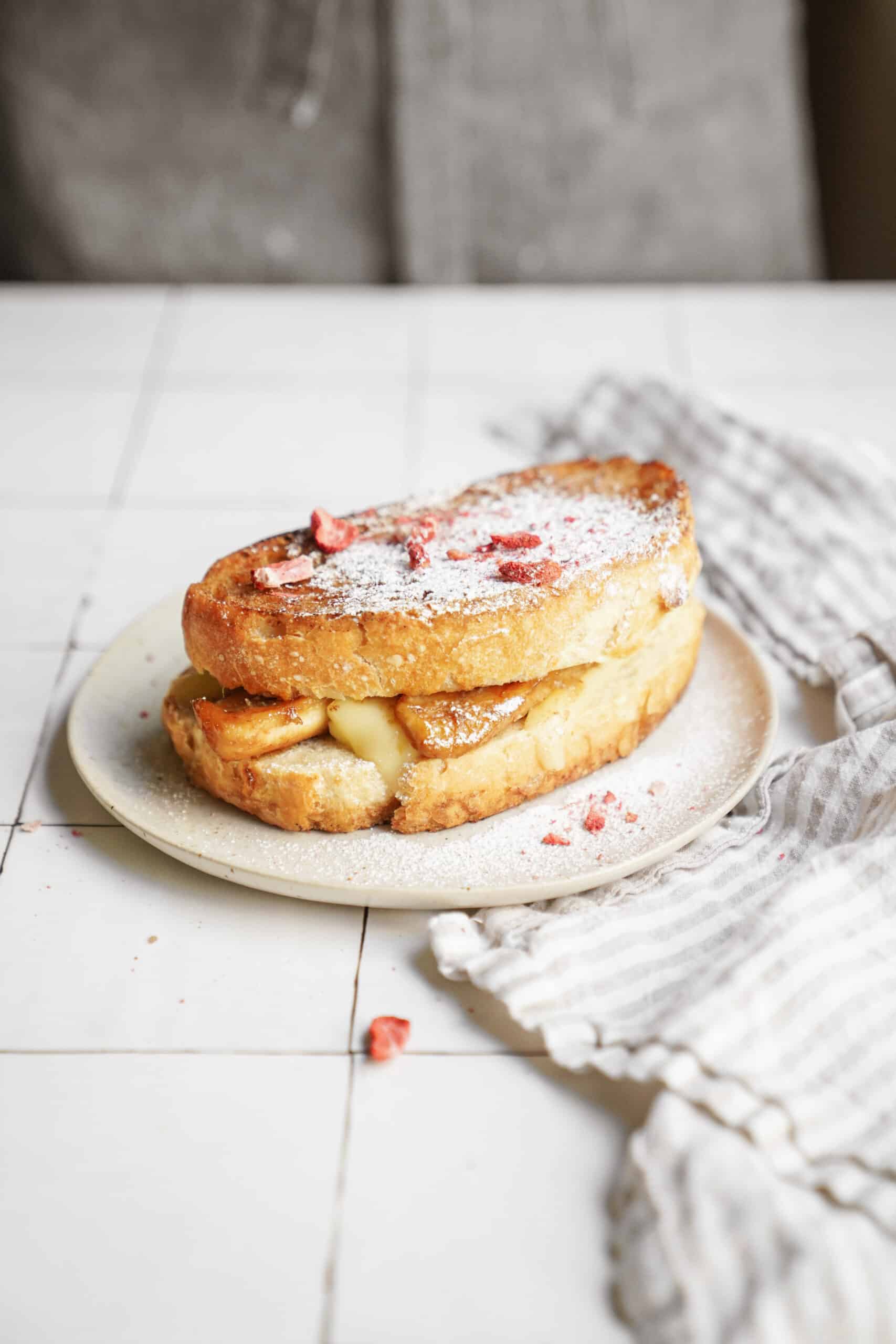 Bananas foster recipe in a grilled cheese form on a white plate