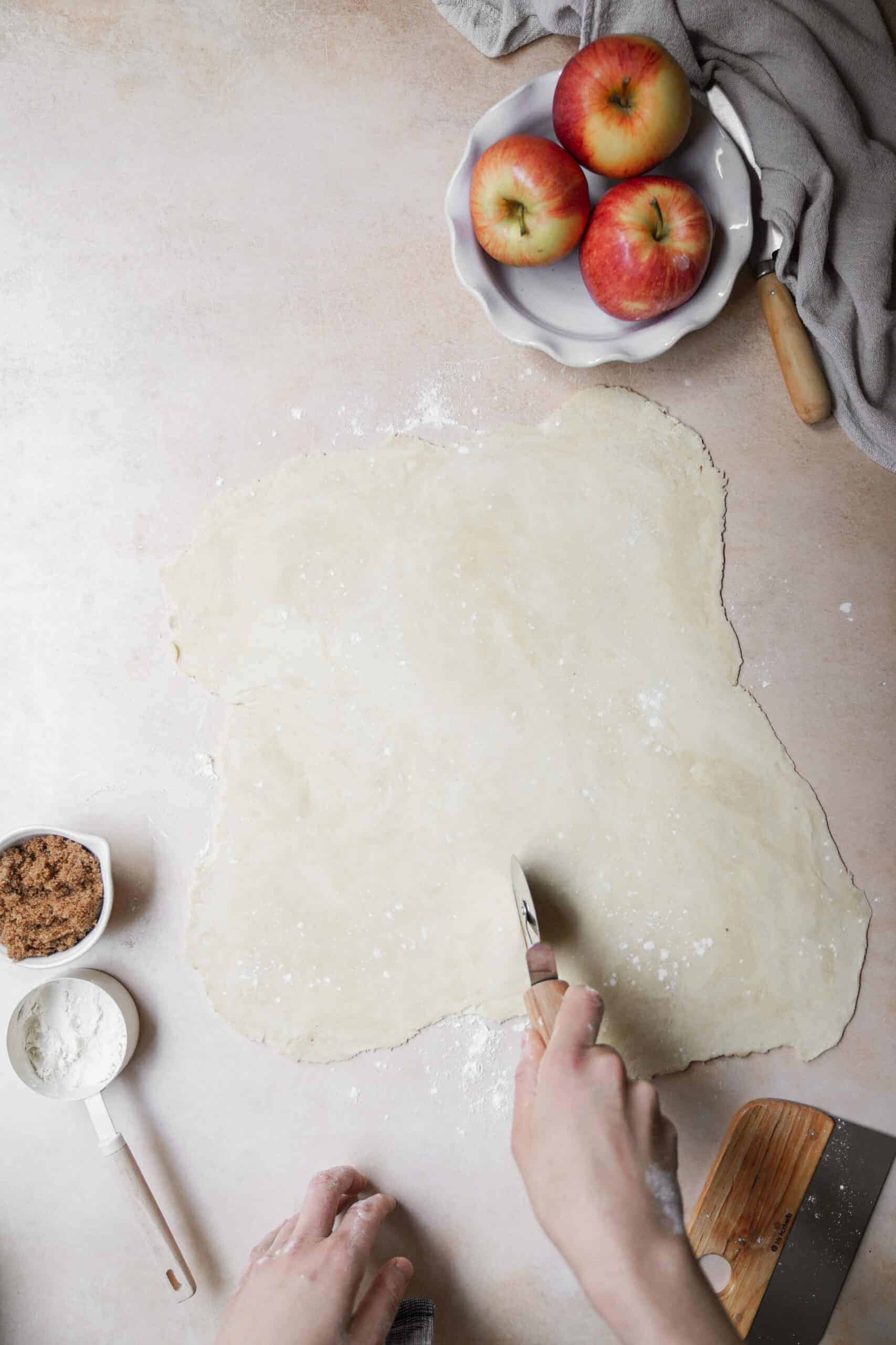 Dough being cut for apple pie