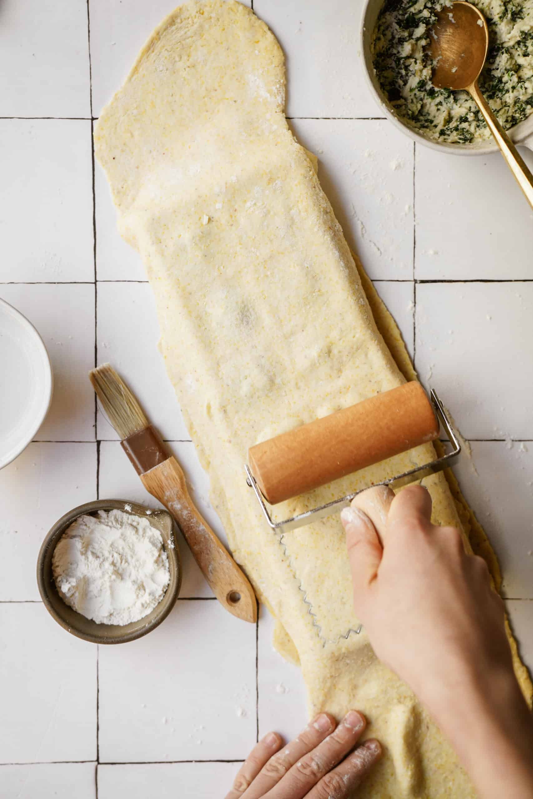 Dough being rolled ontop of ravioli maker