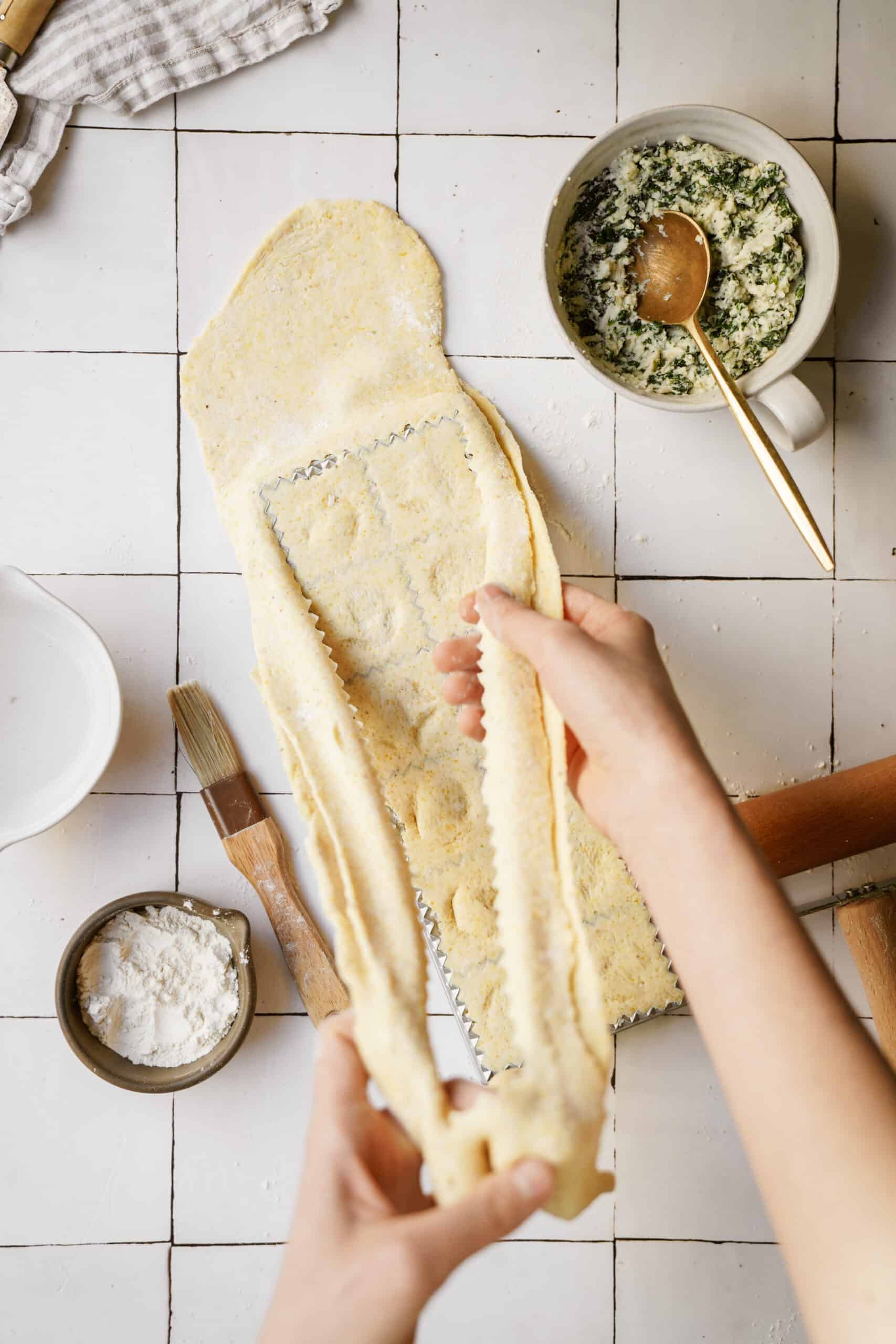 Access dough being removed from ravioli maker