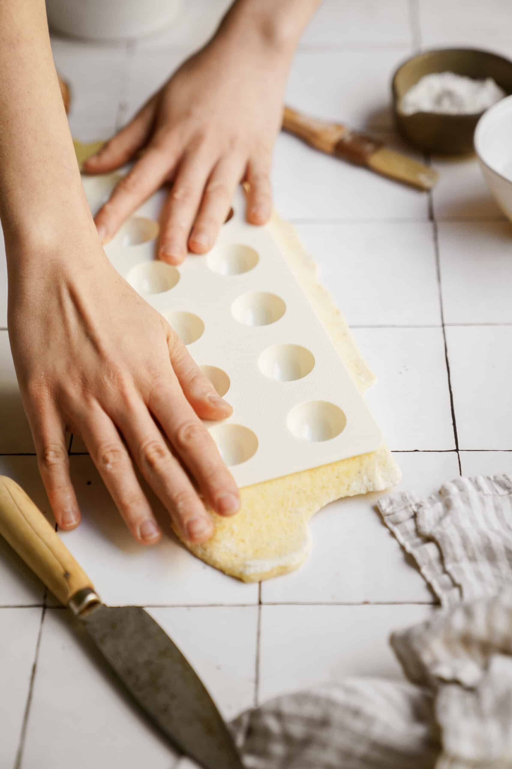 Dough being pressed on ravioli maker