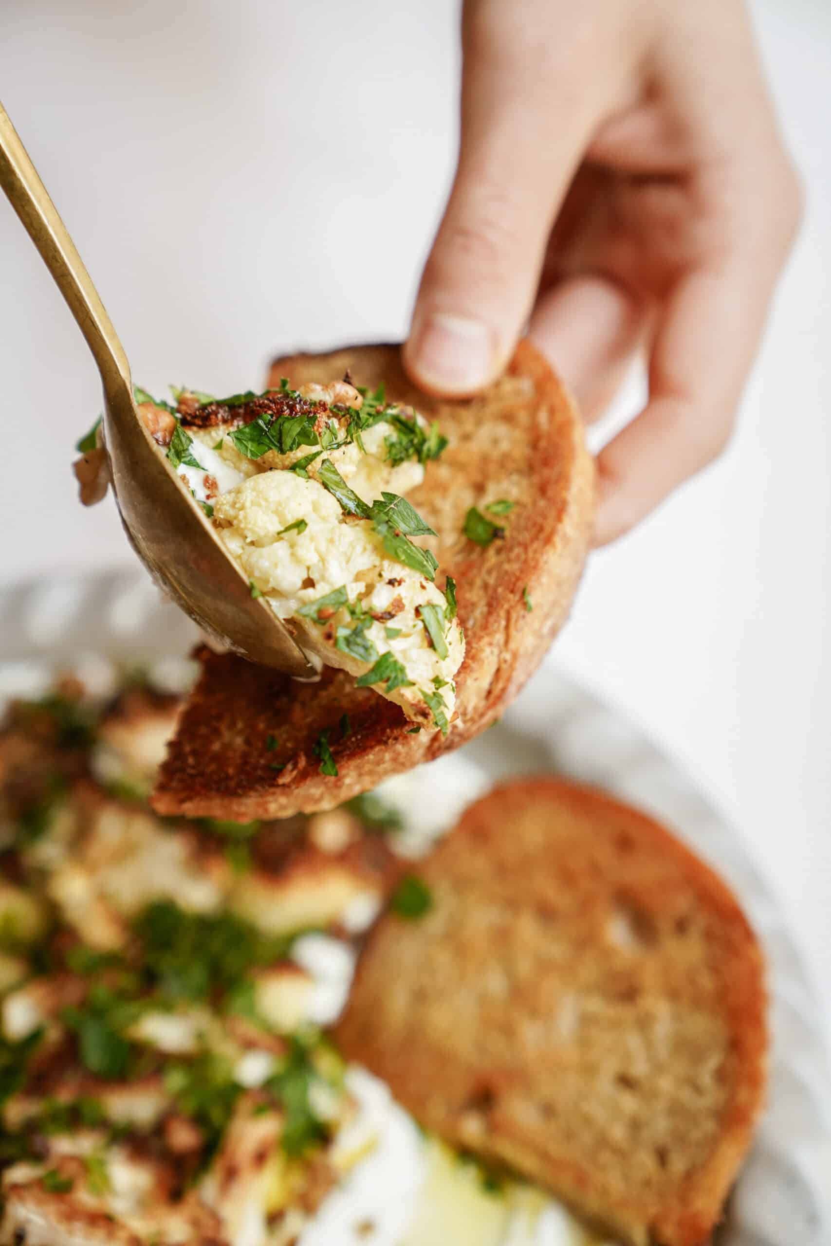 Pita chip dipping into whipped feta dip