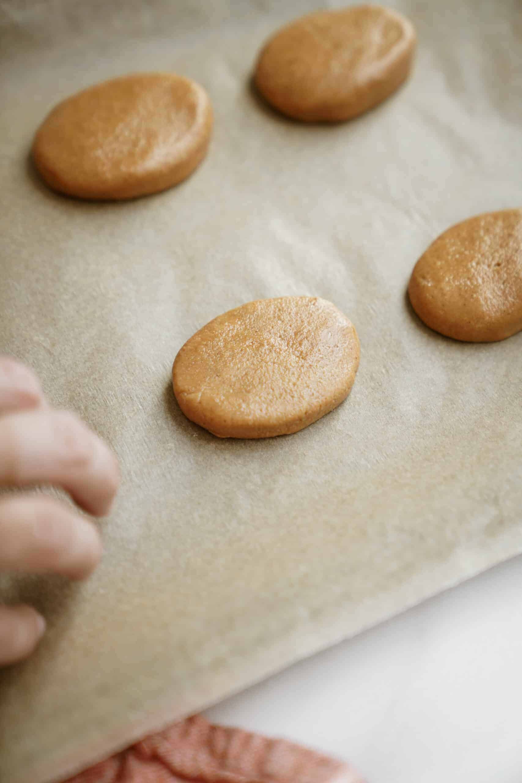 Laying the Homemade Reese's Eggs on a parchment tray 