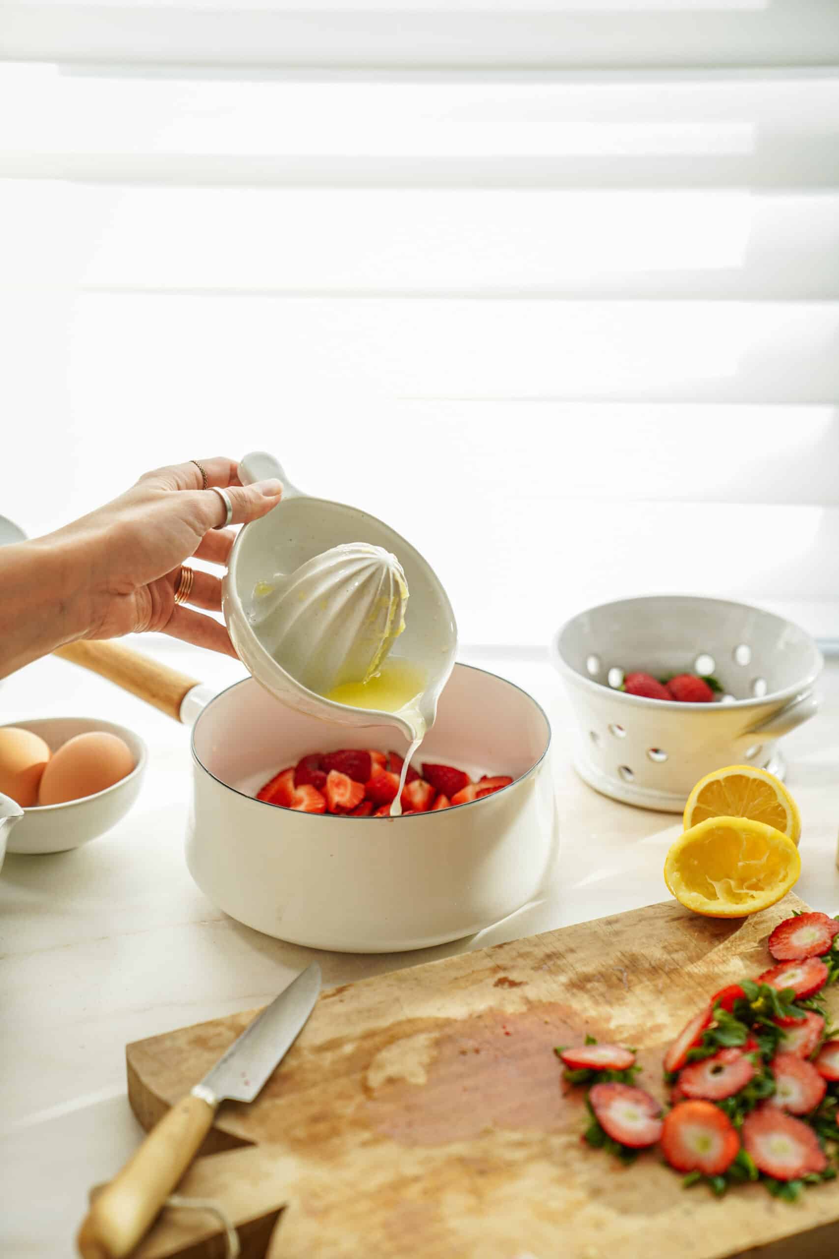 Lemon juice being added to strawberries