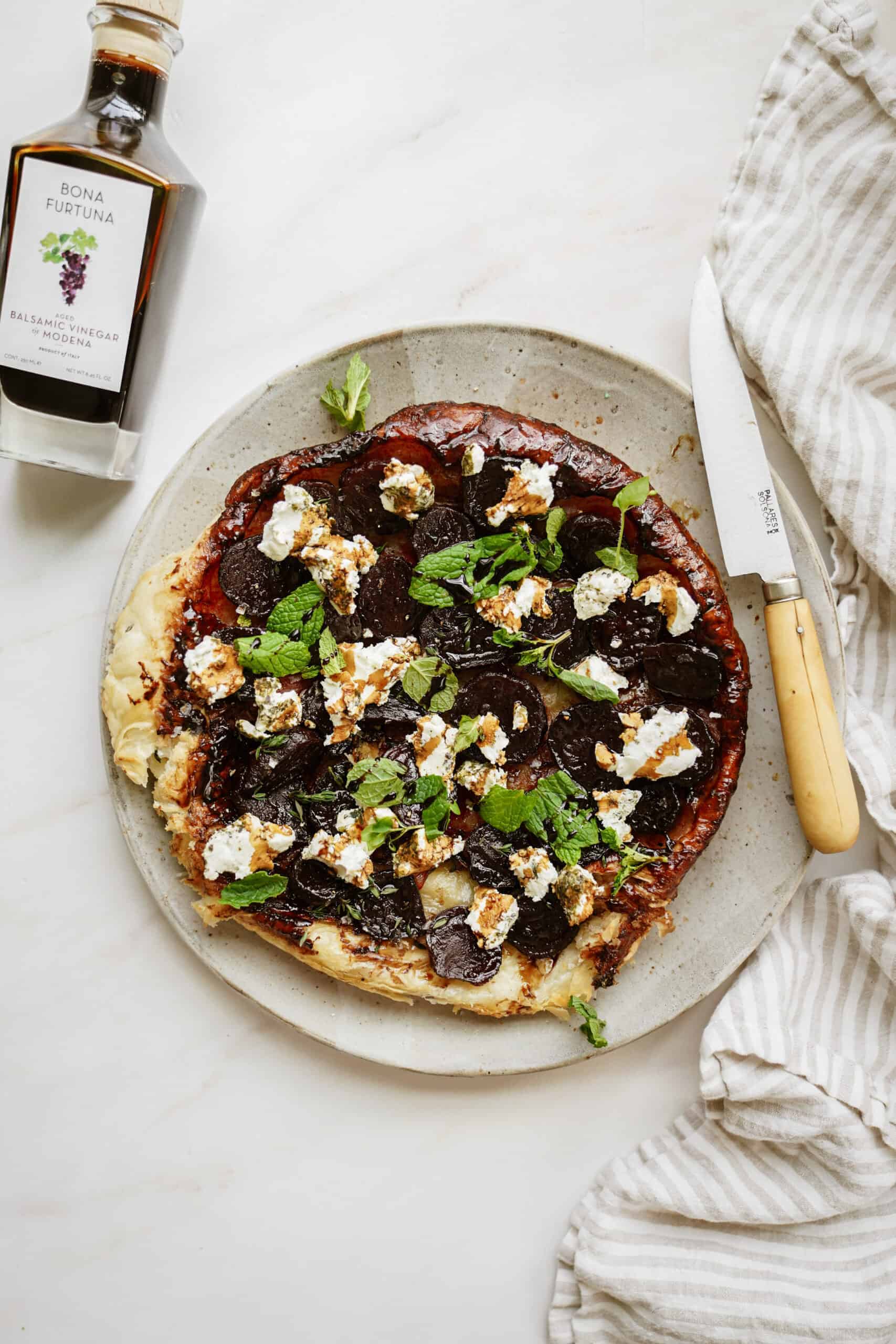 Balsamic and goat's cheese tart on counter with knife