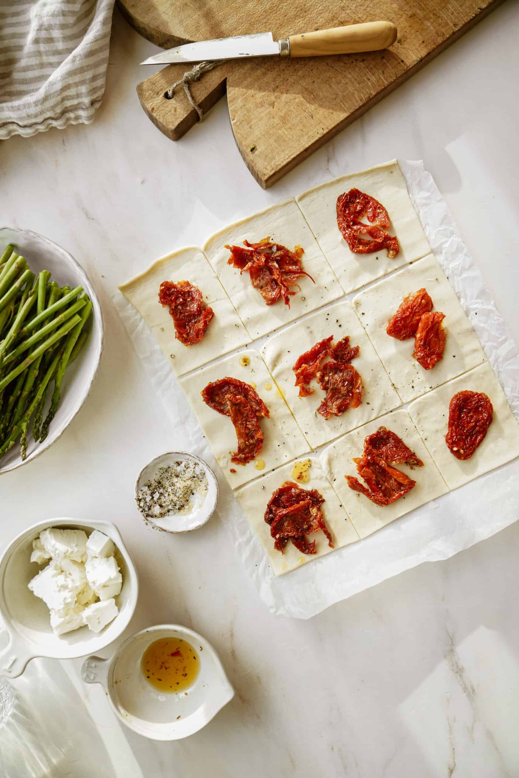 Puff pastry being stuffed with sundried tomatoes for Puff Pastry Bundles