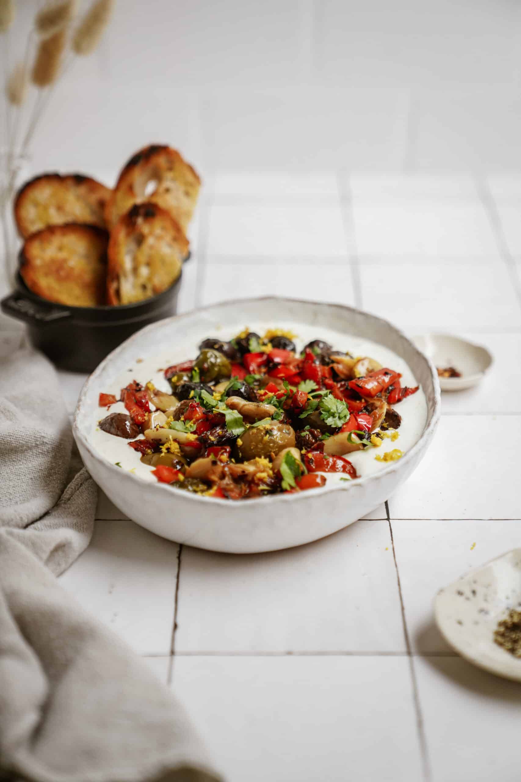 Whipped feta with roasted veggies in a serving bowl