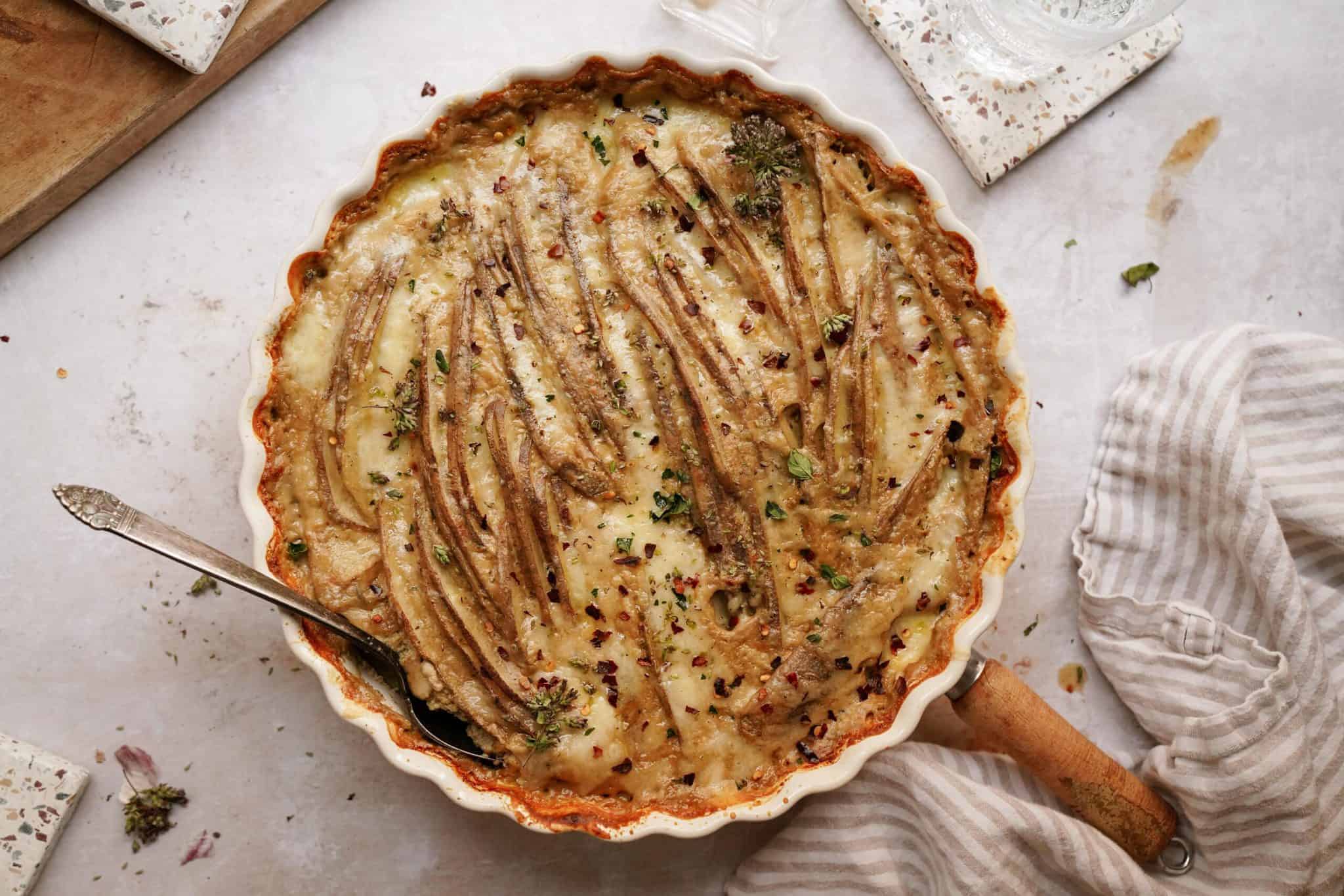 The best scalloped potatoes recipe in a casserole dish on a counter