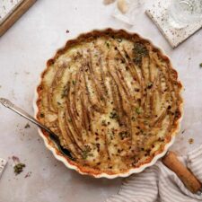 The best scalloped potatoes recipe in a casserole dish on a counter