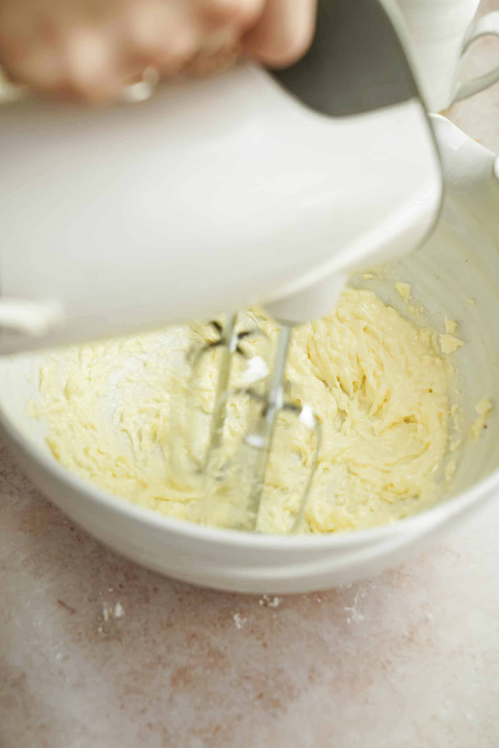 Wet ingredients being beaten in a bowl