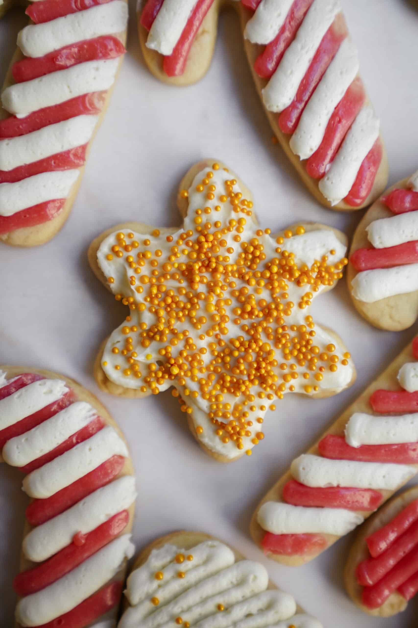 Snowflake sugar cookie on sheet with other sugar cookies for my guide on how to make sugar cookies