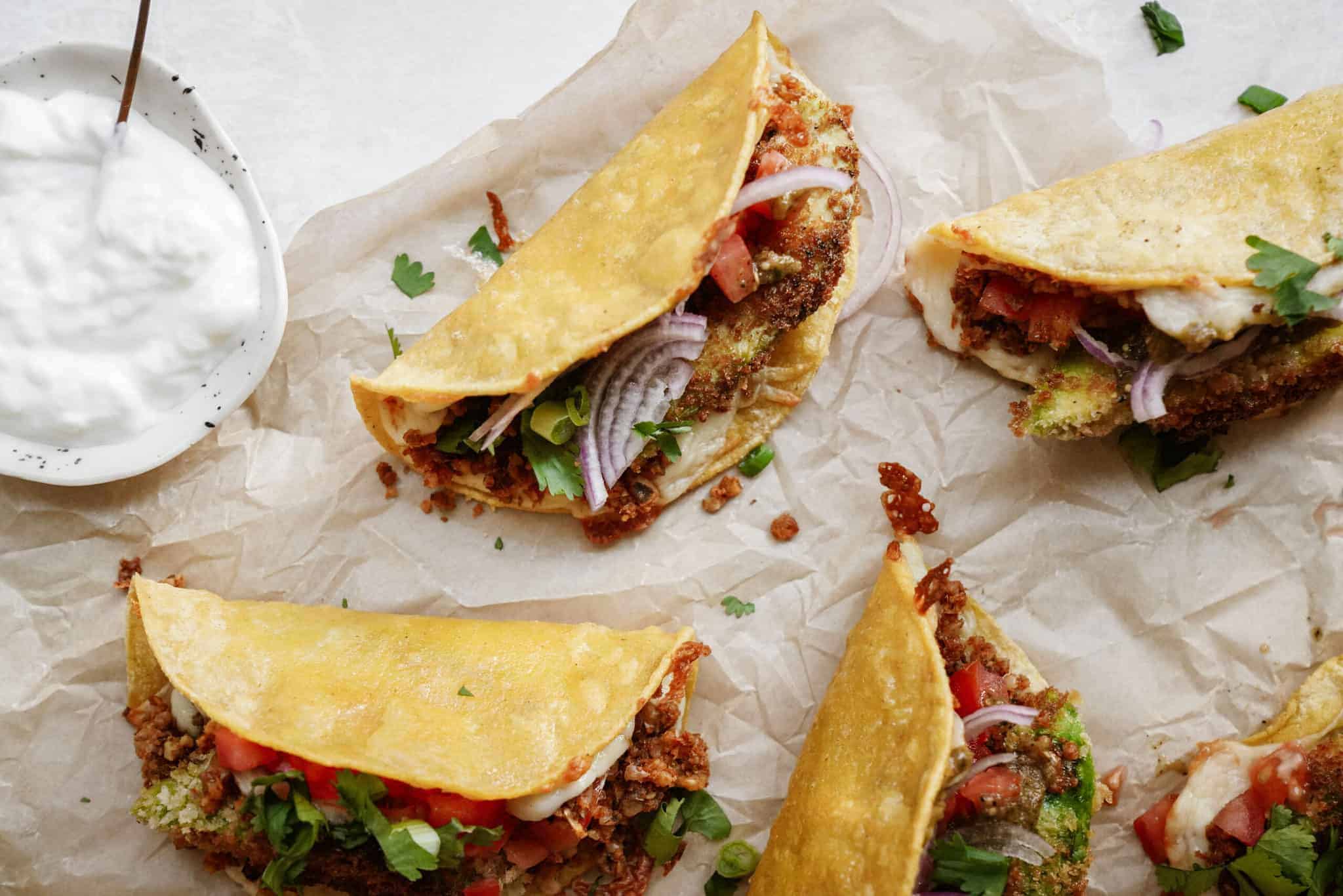 Oven baked tacos laying on parchment paper 