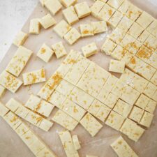 Holiday Shortbread Bites cut into squares on parchmant