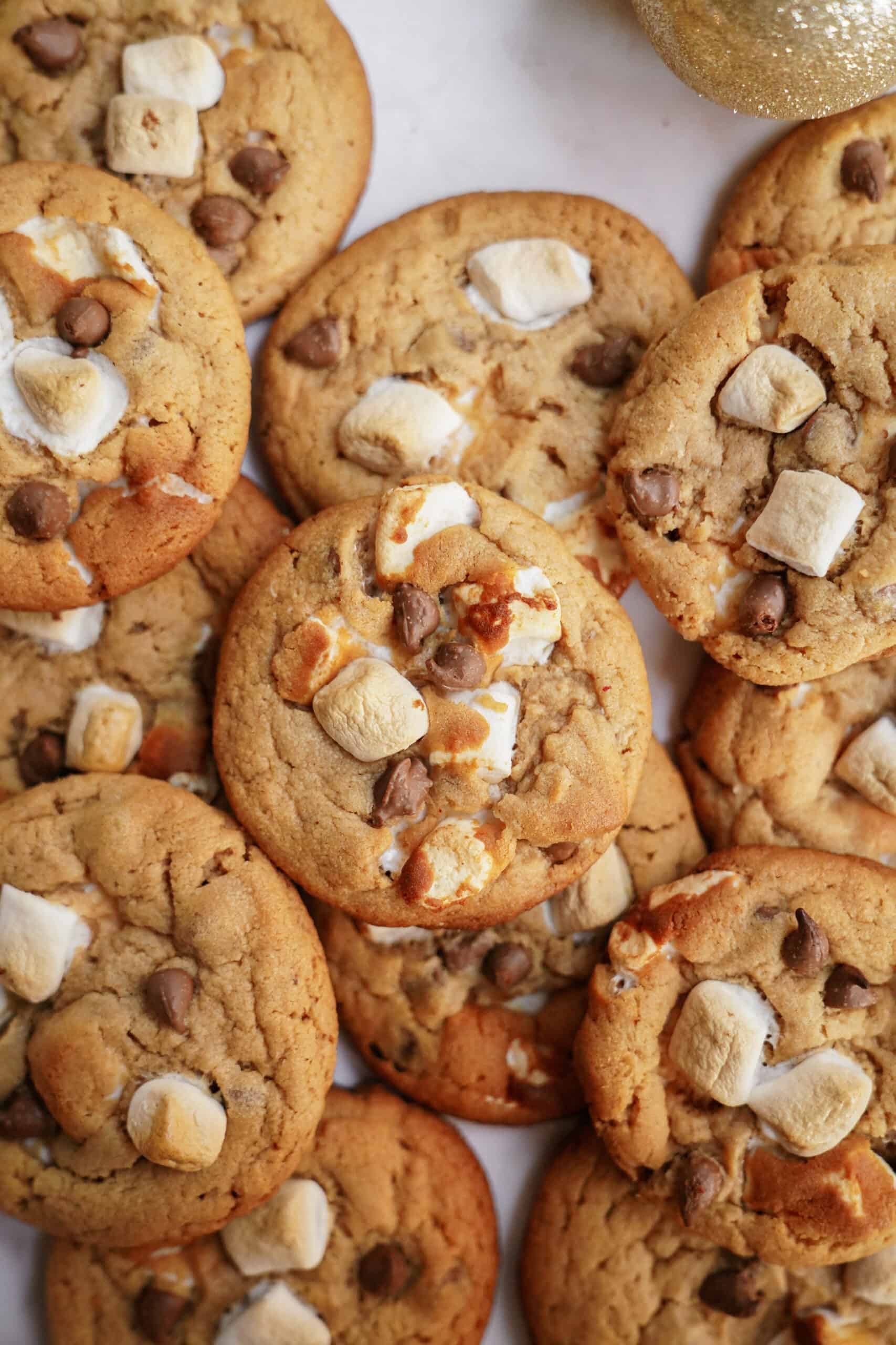 s'mores cookies stacked and scattered on a counter