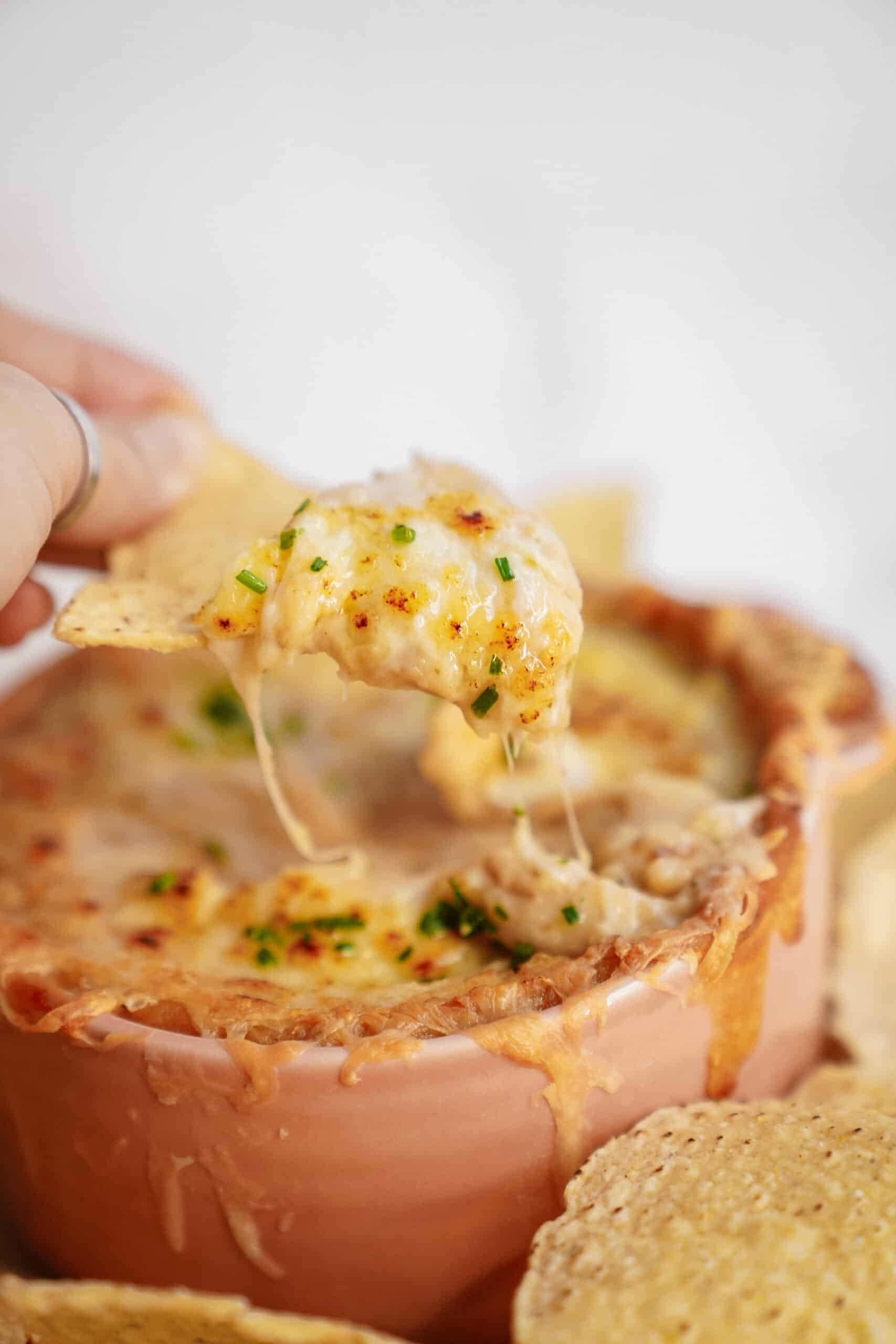 White Bean Dip being dipped with a nacho chip