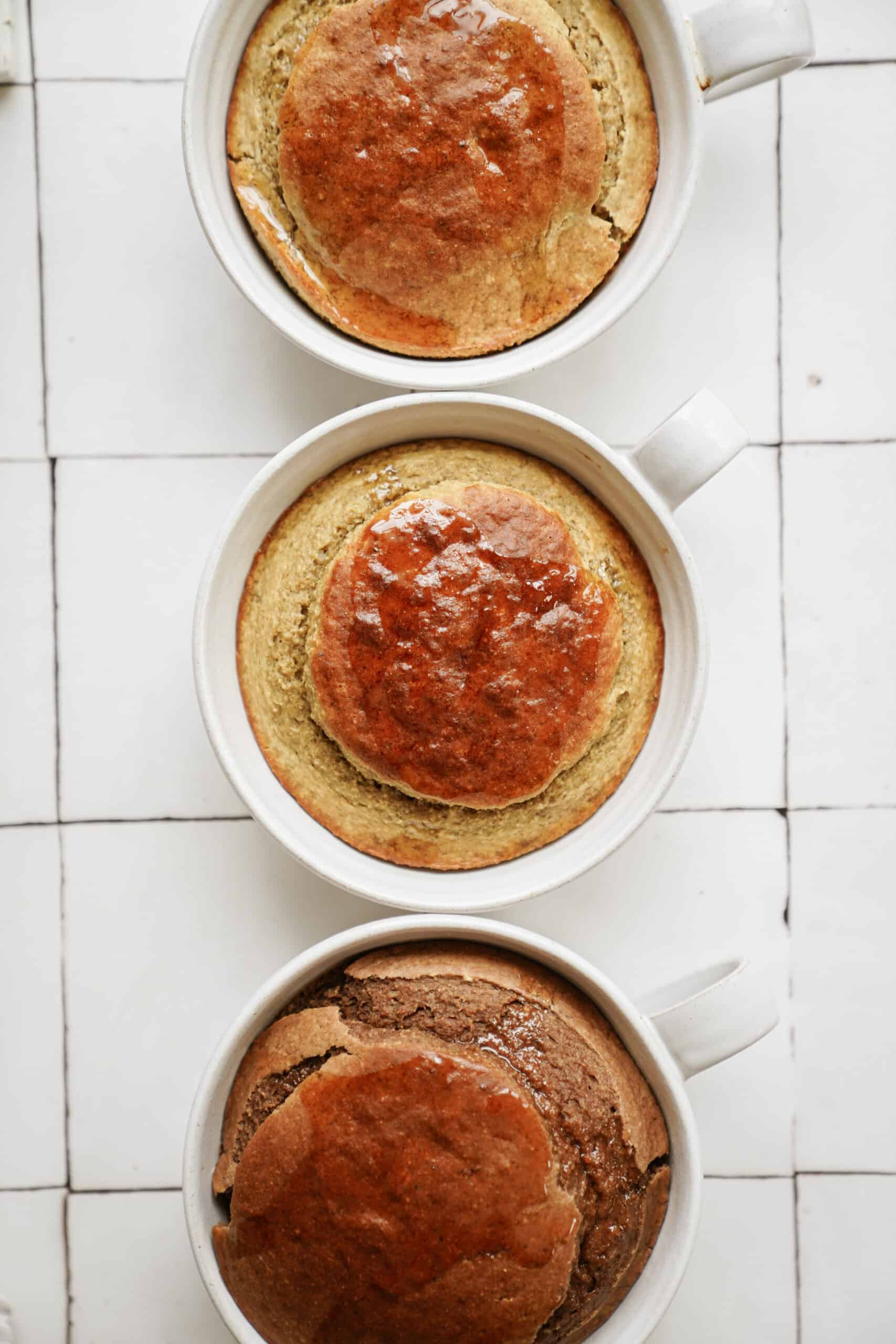 Three mugs with baked oats recipes in each