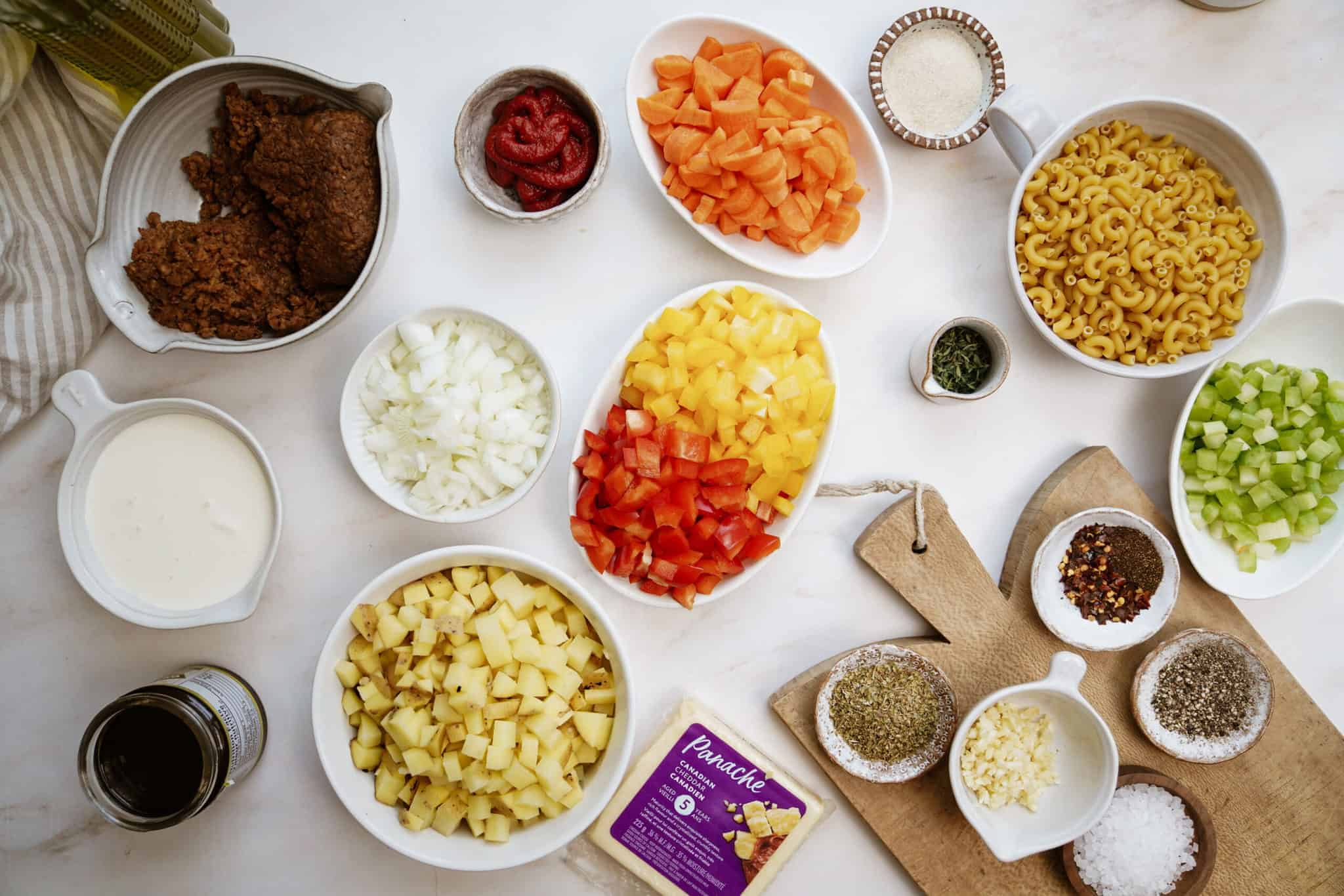 Fresh ingredients for cheeseburger soup on a counter