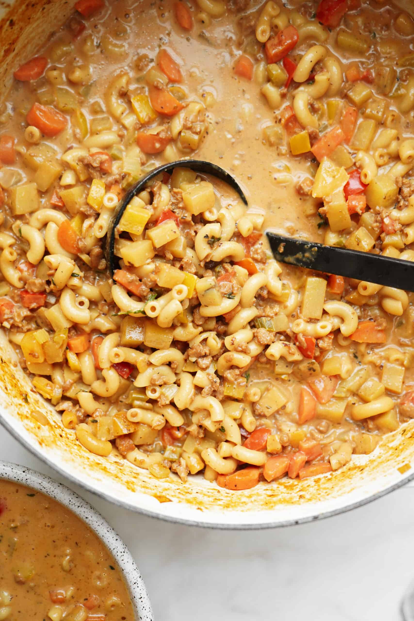 Close-up of big ladle in a pot of cheeseburger soup