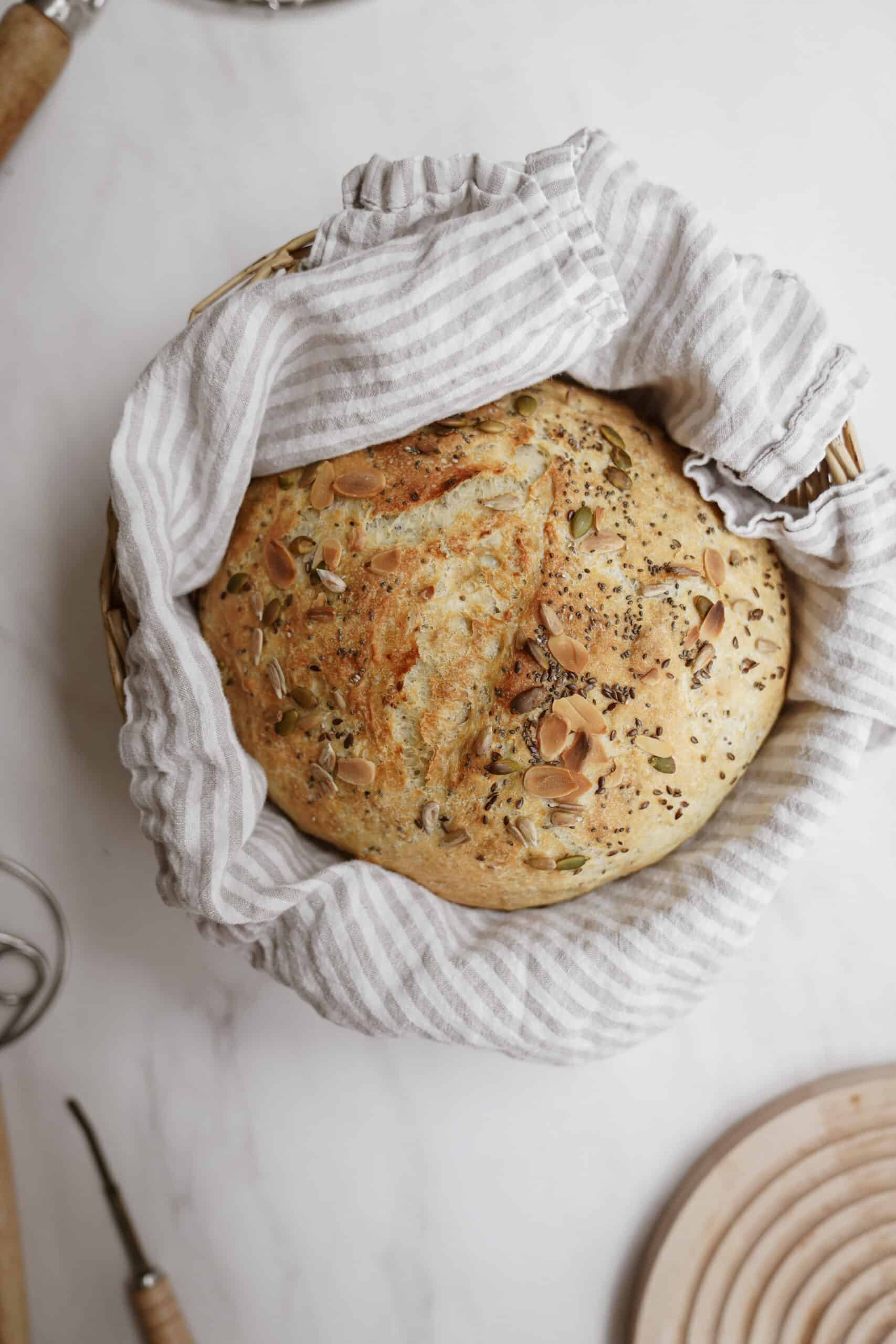 One of my fav dutch oven bread recipes for no-knead seedy bread. Bread in a basket.