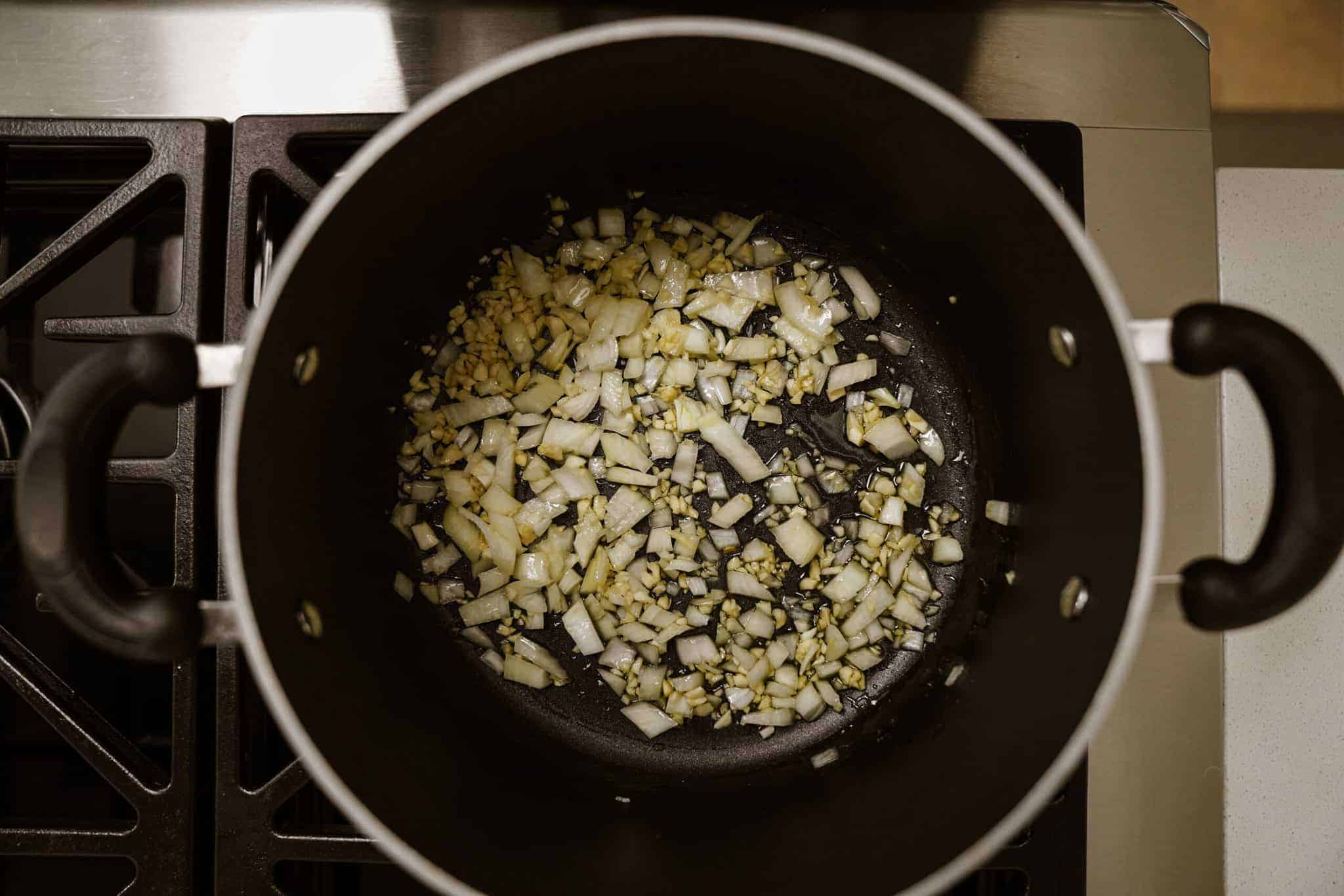 Onions in soup pot for creamy noodle soup