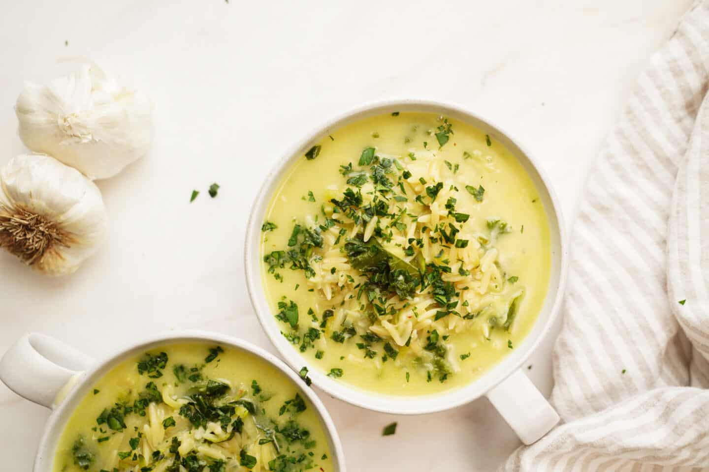 Lemon chicken orzo soup in bowls on a counter