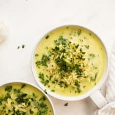 Lemon chicken orzo soup in bowls on a counter